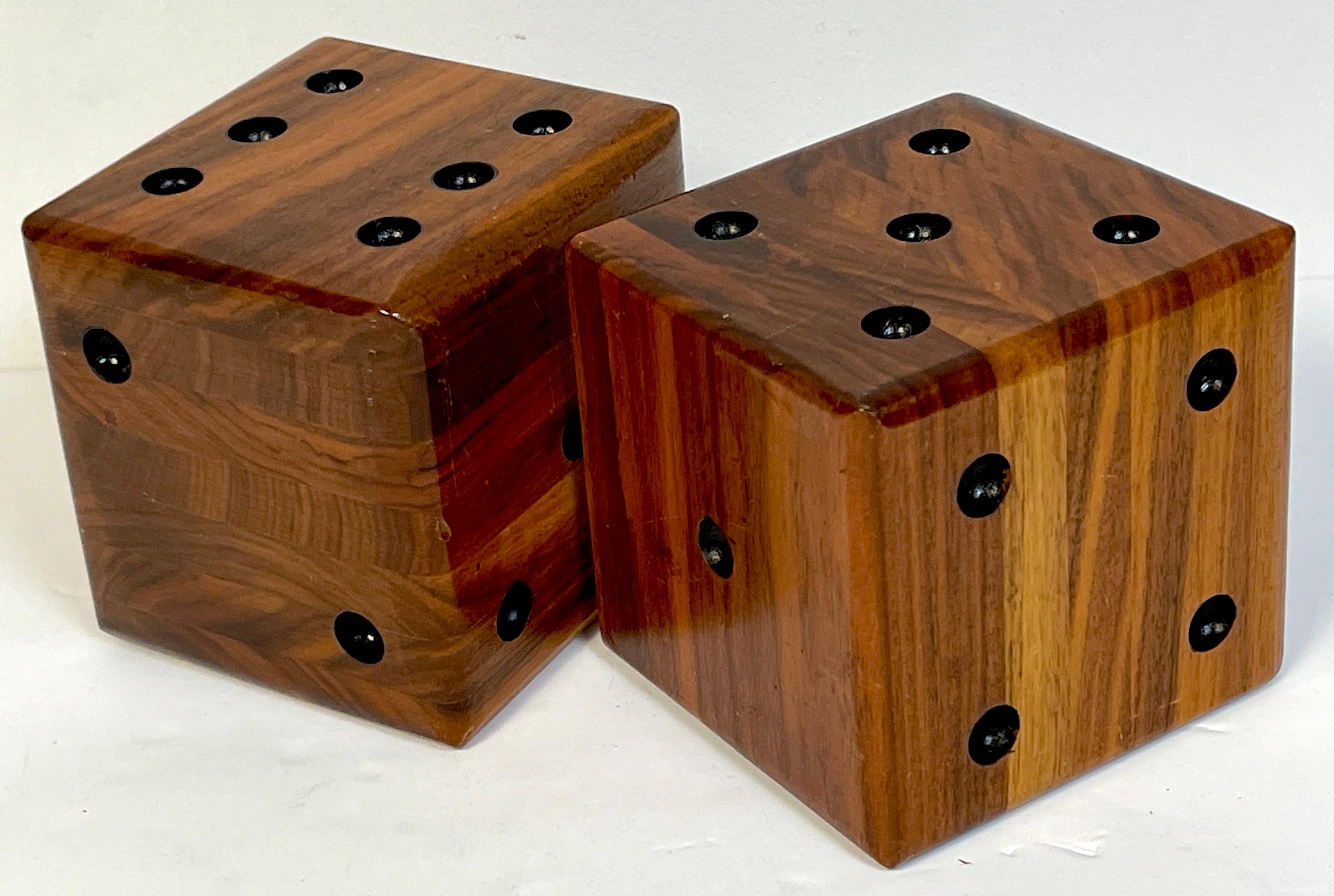 Pair of oversized Macassar ebony carved Casino Dice, France, Circa 1950s

Each one a hefty example made of seven sections book-matched Macassar Ebony wood, with carved /incised ebonized pips representing the numbers on the dice.

Believed to be