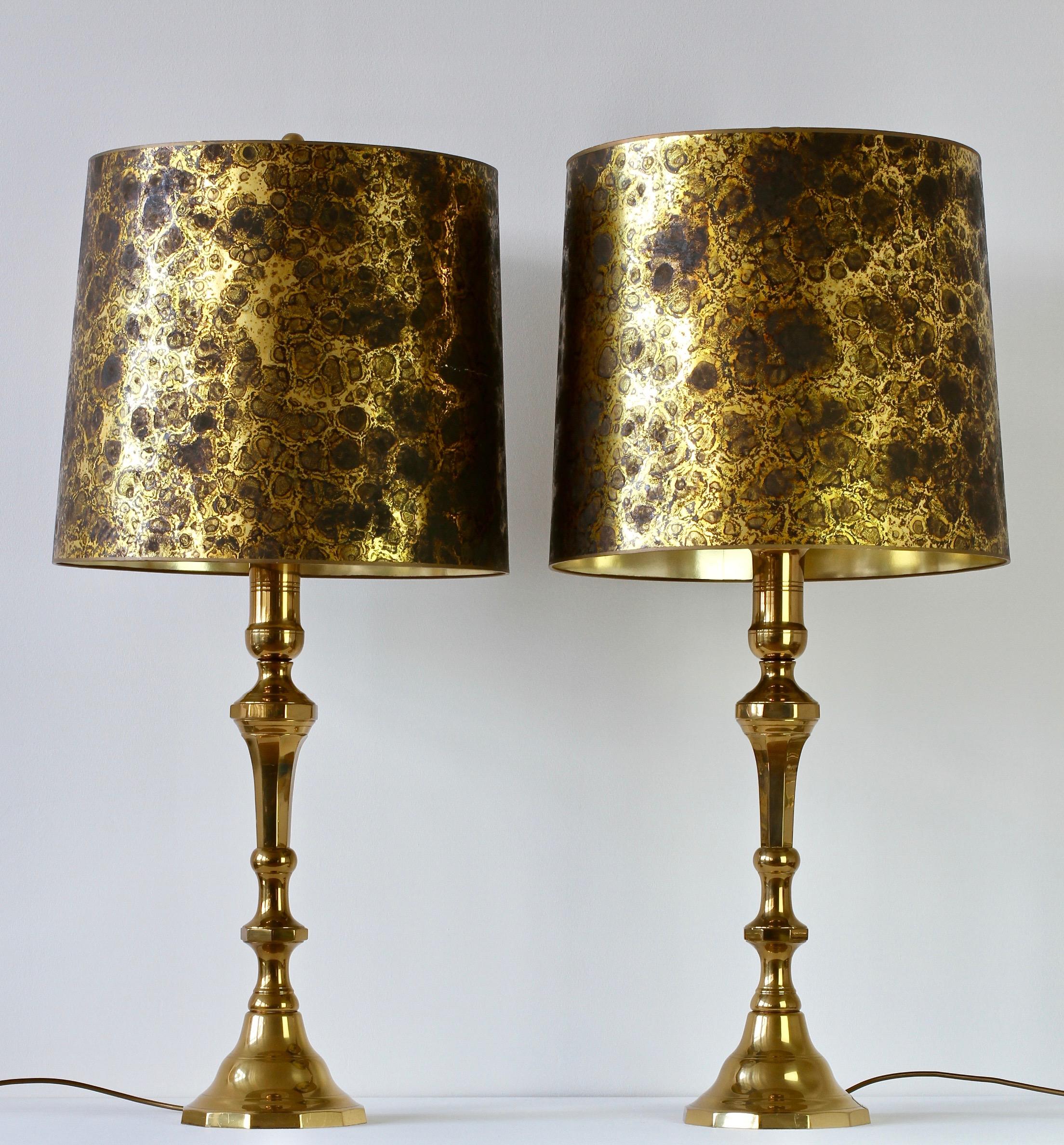 Monumental and tall Mid-Century Modern pair of oversized, large-scale table or floor lamps in the style of Maison Jansen, circa 1970s. Featuring cast polished brass, these lamps lend themselves to any modern home decor as well as the Mid-Century