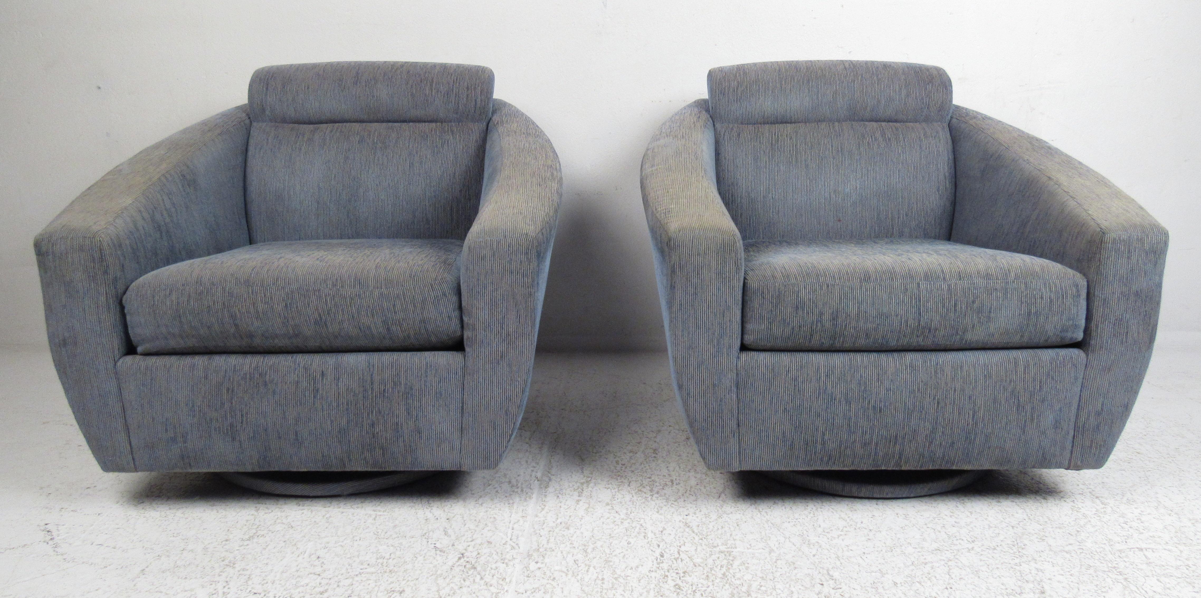 Modern style pair of oversized lounge chairs with swivel and tilting base. Please confirm item location (NY or NJ) with dealer.