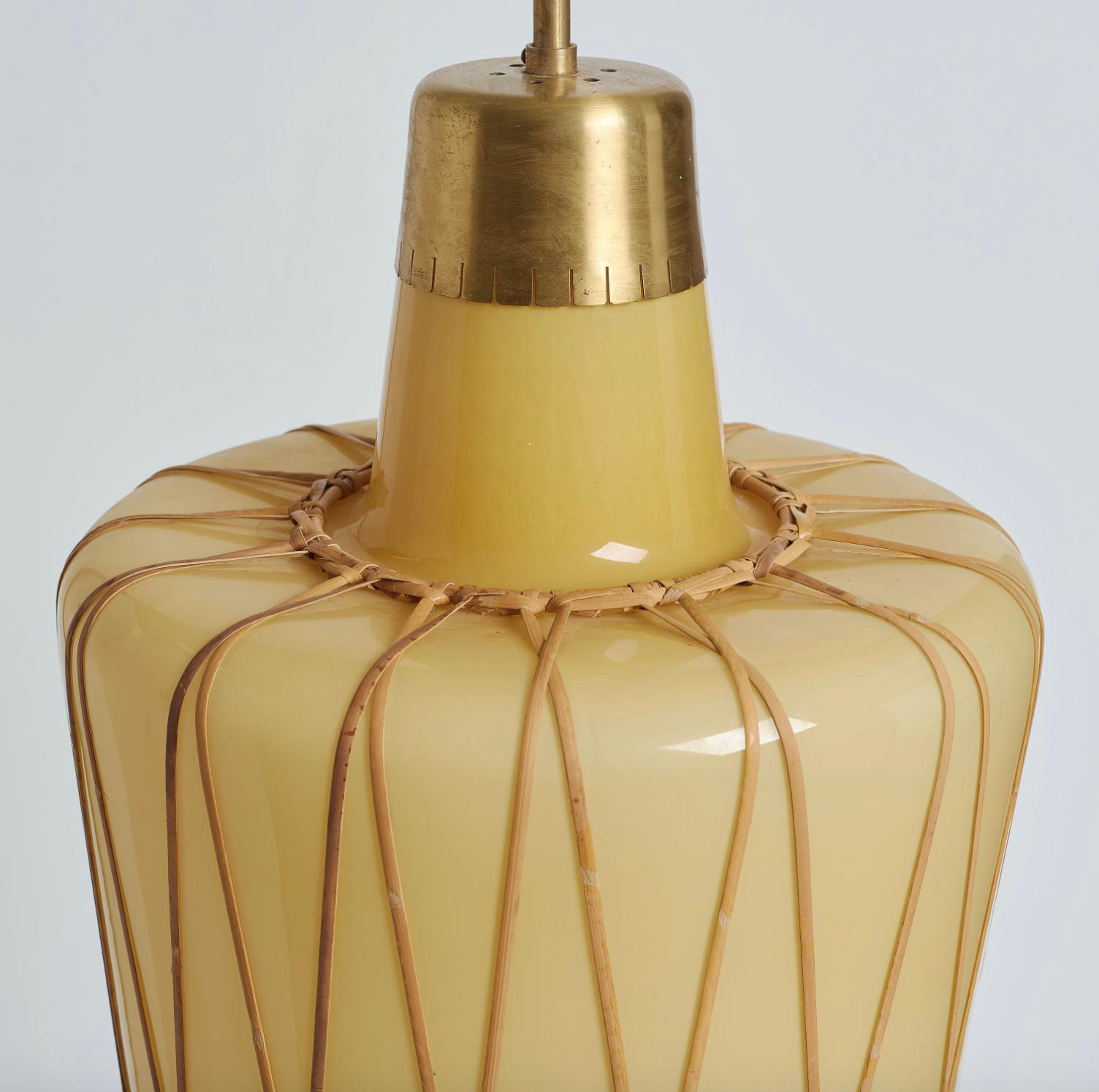 Pair of oversized pendants by Carl Westman attributed, Sweden, circa 1930-1940. Handblown, double layer white and vanilla glass with rattan cage. Measures: Diameter 16?. Drop 36?. Can be sold separate. Total 4 items available. Price is for each.