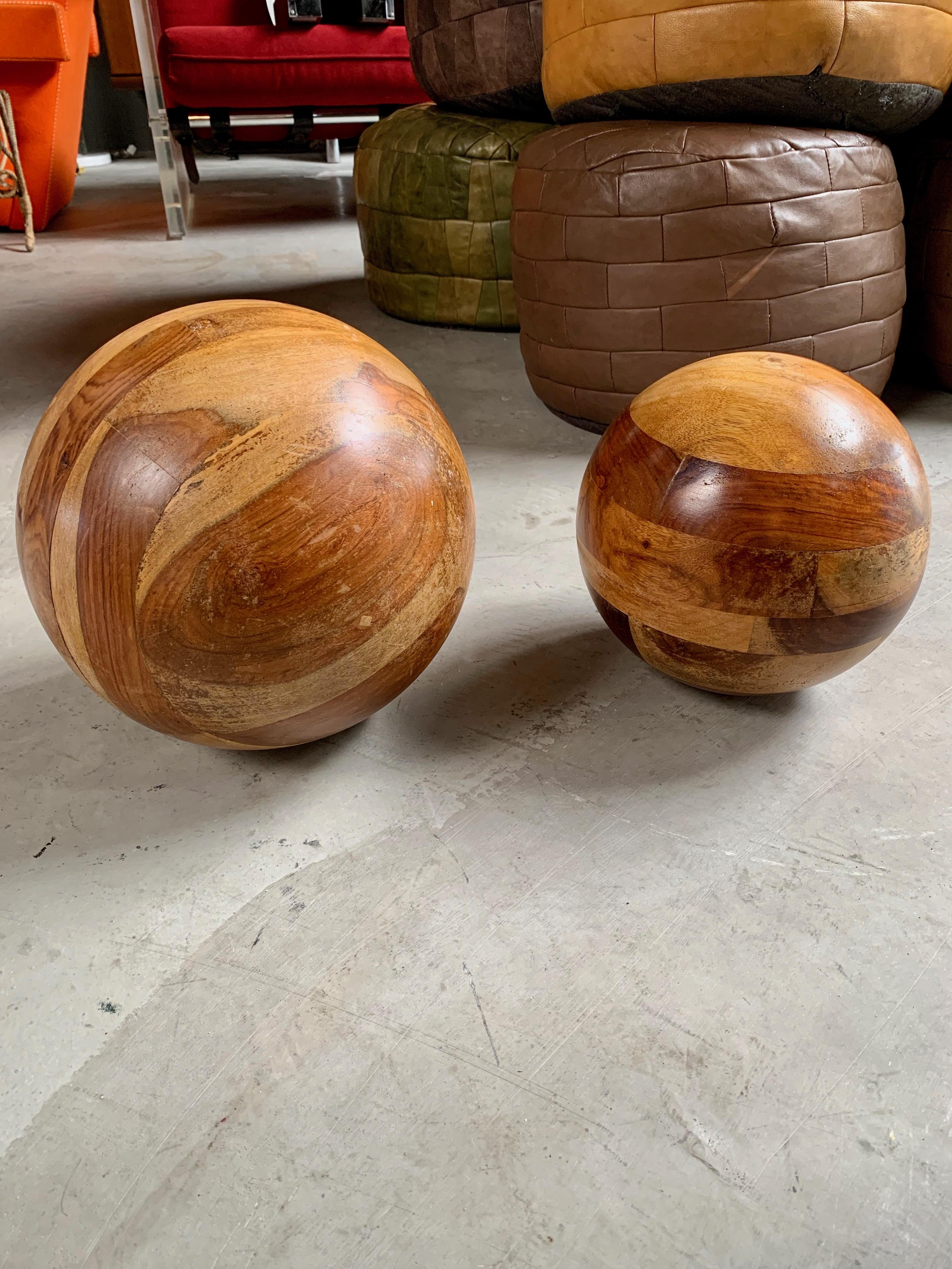 Great sculptural pair of wood balls. Made of strips of wood fused together. Large ball approximately 11