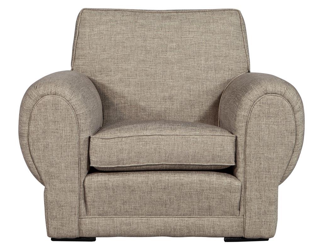 This vintage set of upholstered oversized armchairs are newly upholstered in a textured linen fabric. It features a comfortable seat, large, padded rolled curved arms and a square back. A great, stylish and comfortable chair for any living room or