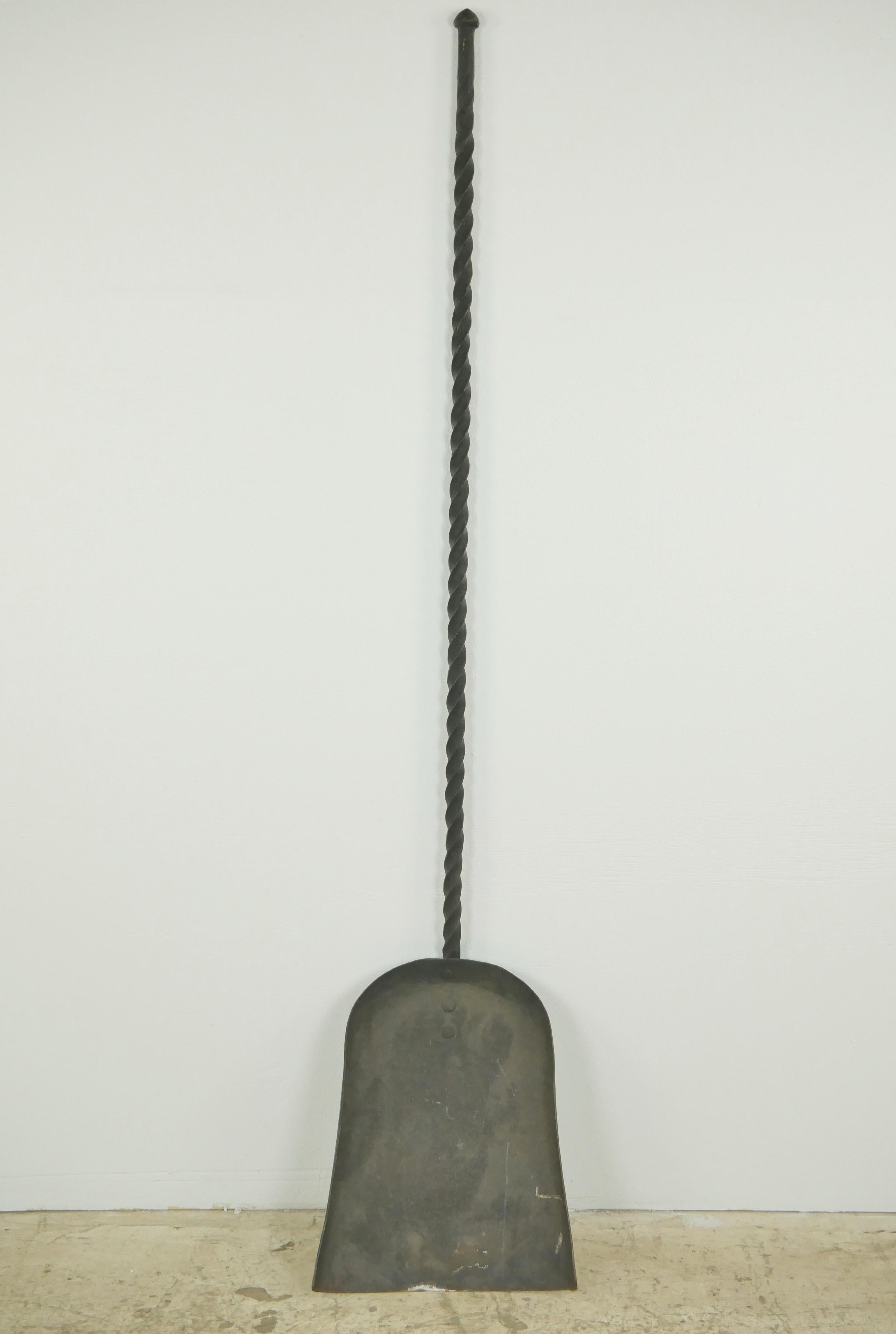 Antique large fireside shovel and fork tools made of wrought iron with a black finish. They both feature a turned design. Good condition with surface wear from prior use. Priced as a pair. Please note, this item is located in our Scranton, PA