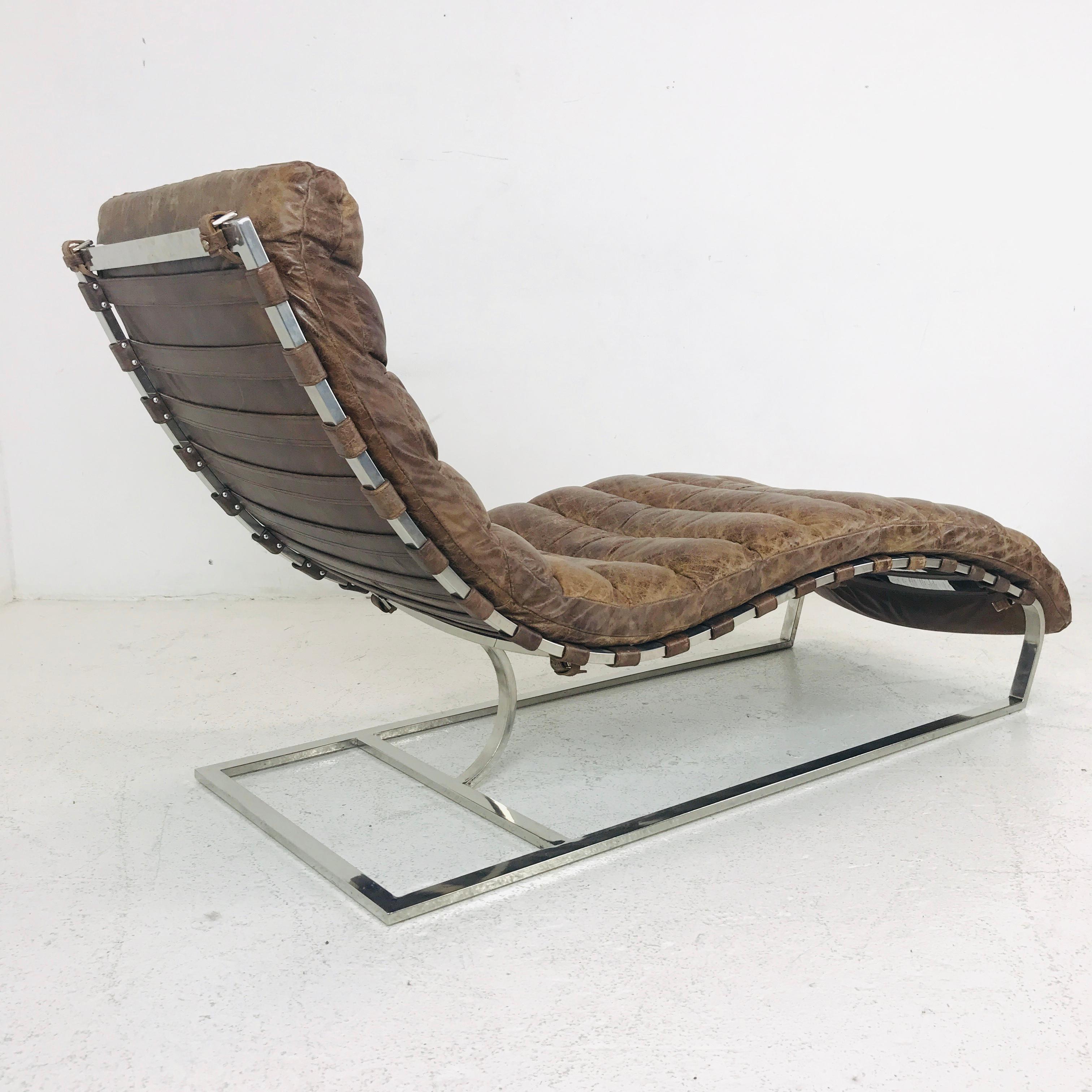 These stylish modern chaise longue chairs feature channeled brown leather with a distressed patina situated on chrome bases. Comfortable lounge design makes these an excellent seating option for home or office.