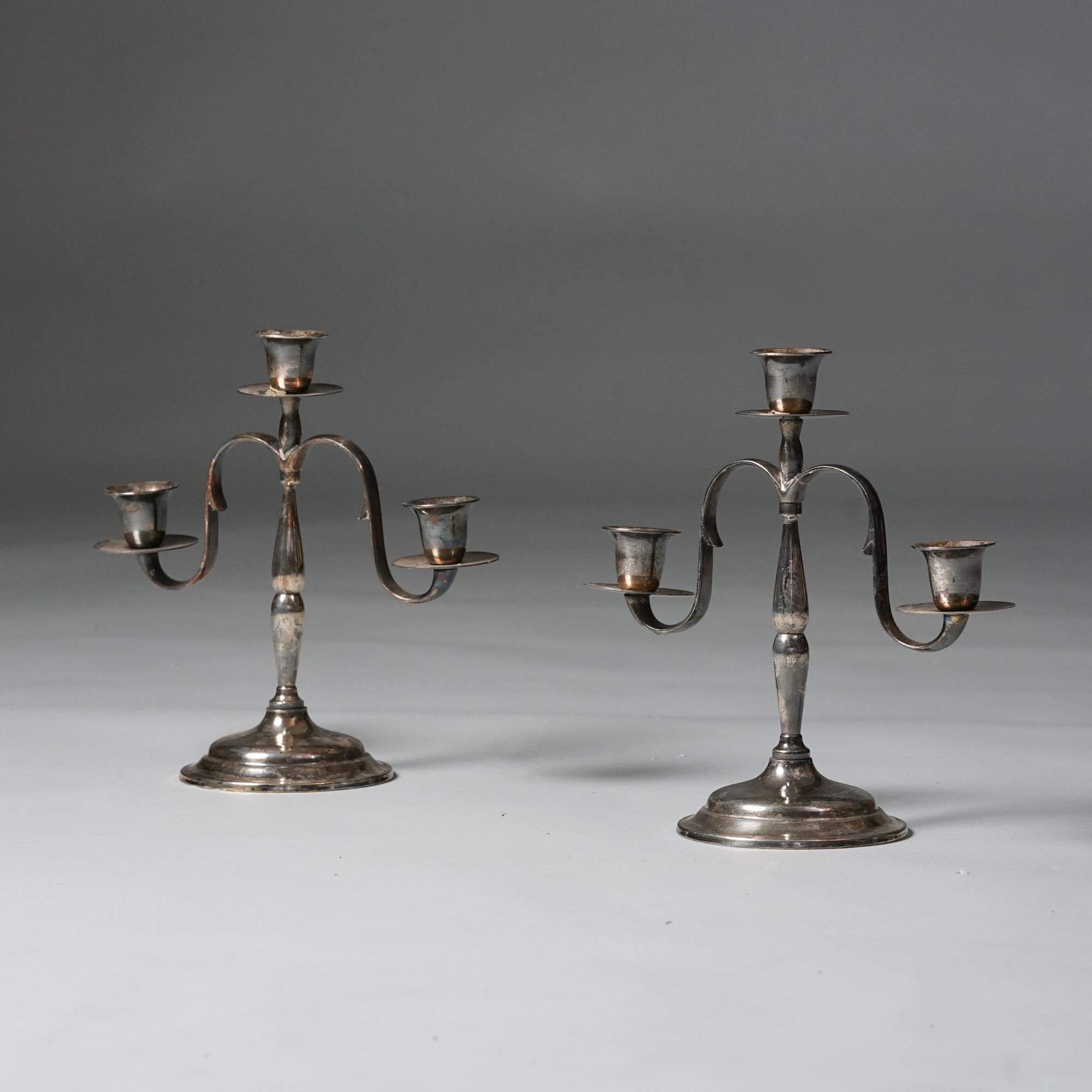 Pair of Paavo Tynell candle sticks for Taito Oy, 1920s. Metal. Good vintage condition, patina consistent with age and use. 

Paavo Tynell (1890-1973) is one of the most important names in Finnish lighting design, and his work has had a significant