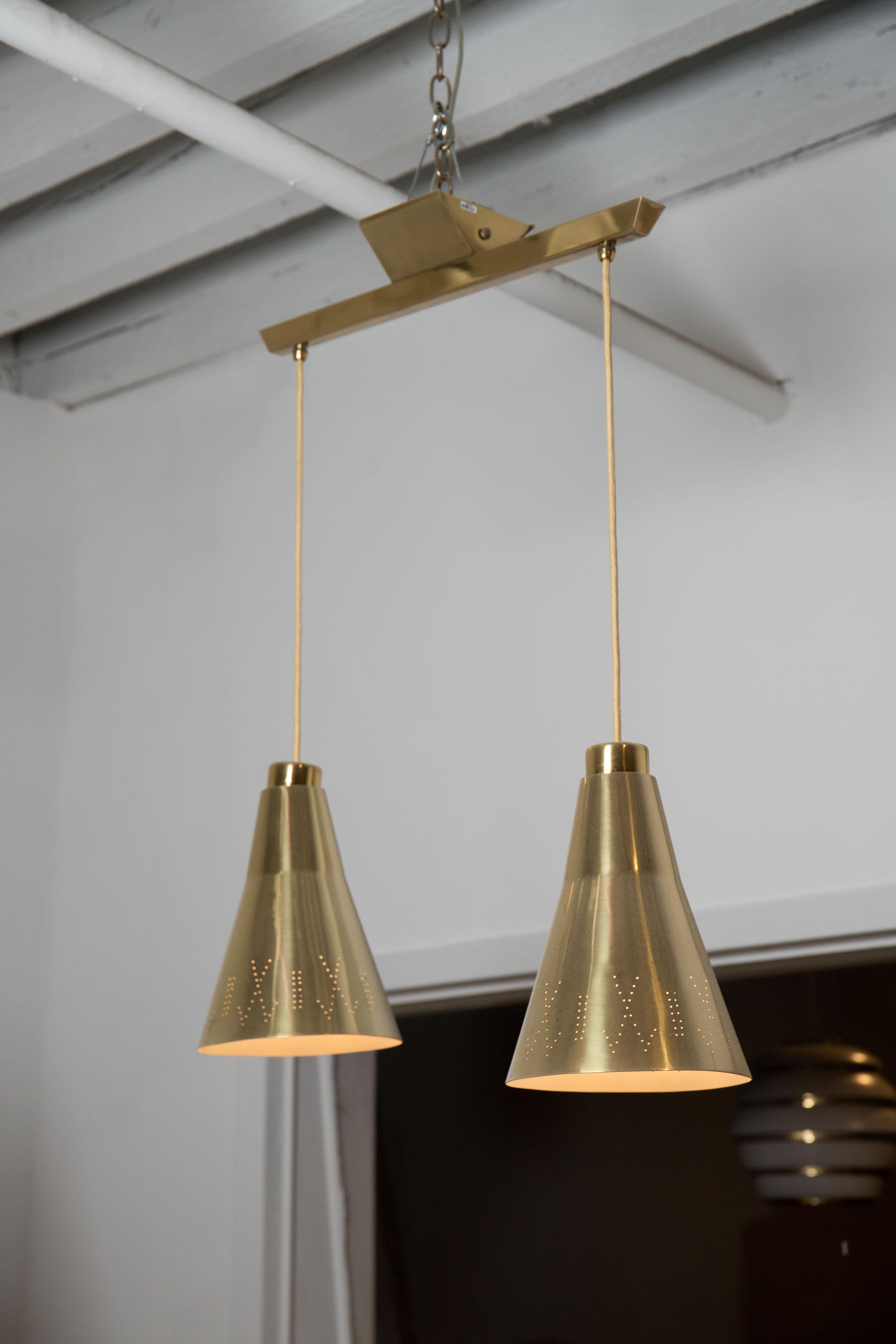 Pair of brass double pendants with perforated shades, designed by Paavo Tynel for Taito Oy, Finland, 1960s.
Brass has been polished and fixtures have been rewired.

Available to view in my gallery in Chelsea, NY.