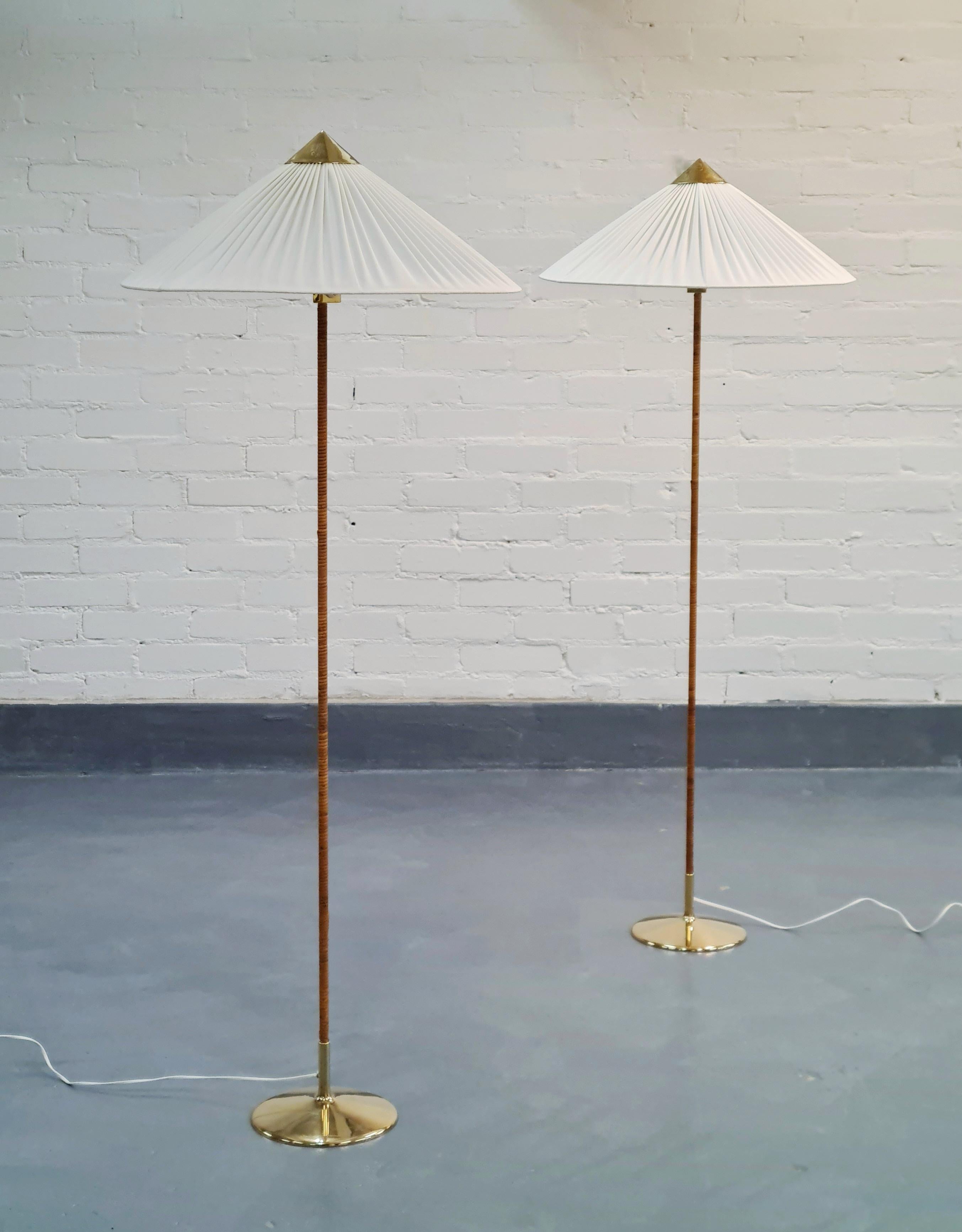 A beautiful pair of the highly sought after Paavo Tynell floor lamps model 9602 aka Chinese hat for Oy Taito Ab. 
This iconic floor lamp was originally designed by Paavo Tynell in the late 1930s and has been refined during the golden era of the