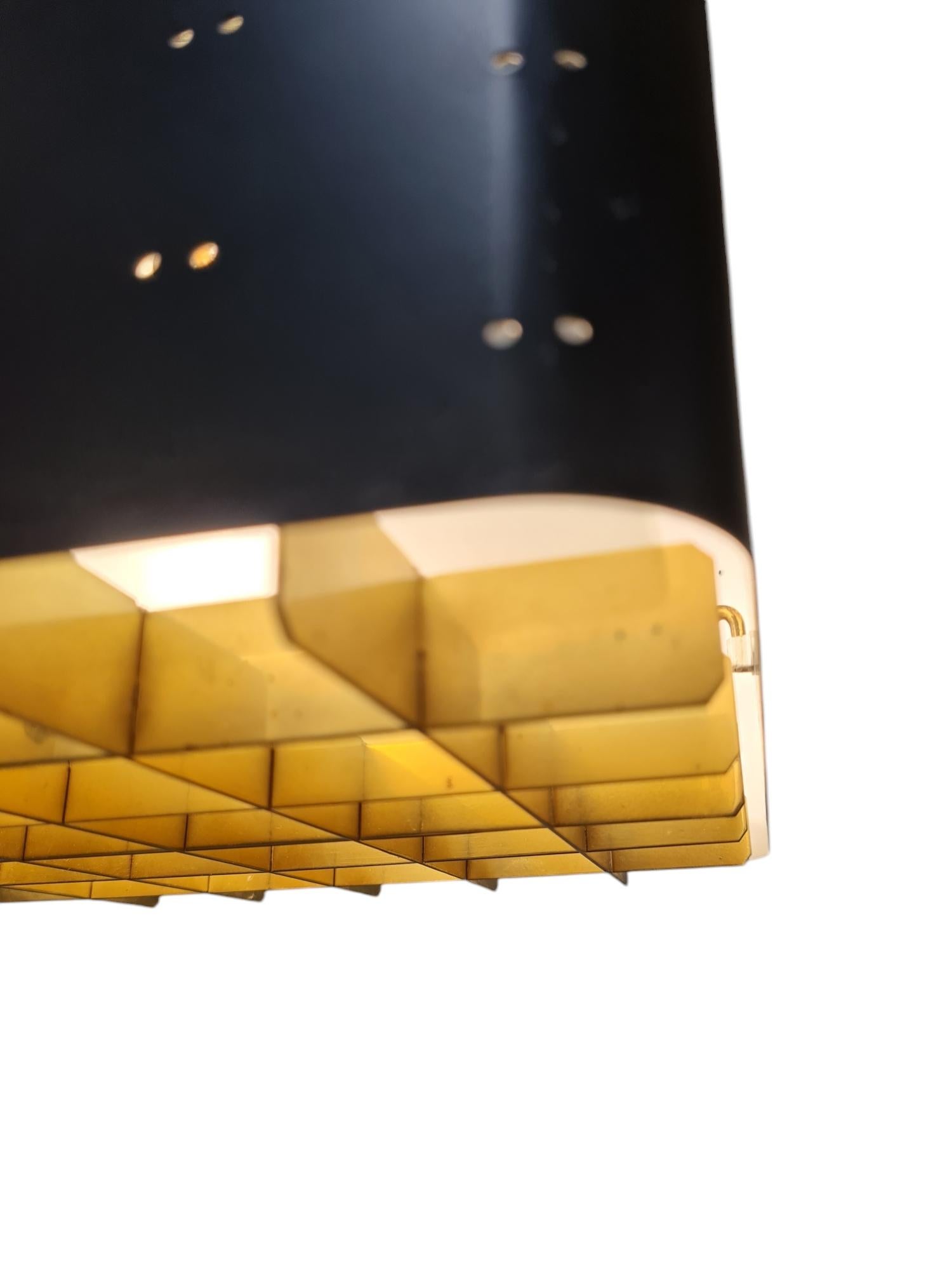 The Starry Sky is one of the most iconic designs of Paavo Tynell's lamps. It was made by both Taito and Idman in many different sizes. The way the light filters through the grill and the holes on the sides makes the ceiling look like a starry sky.
