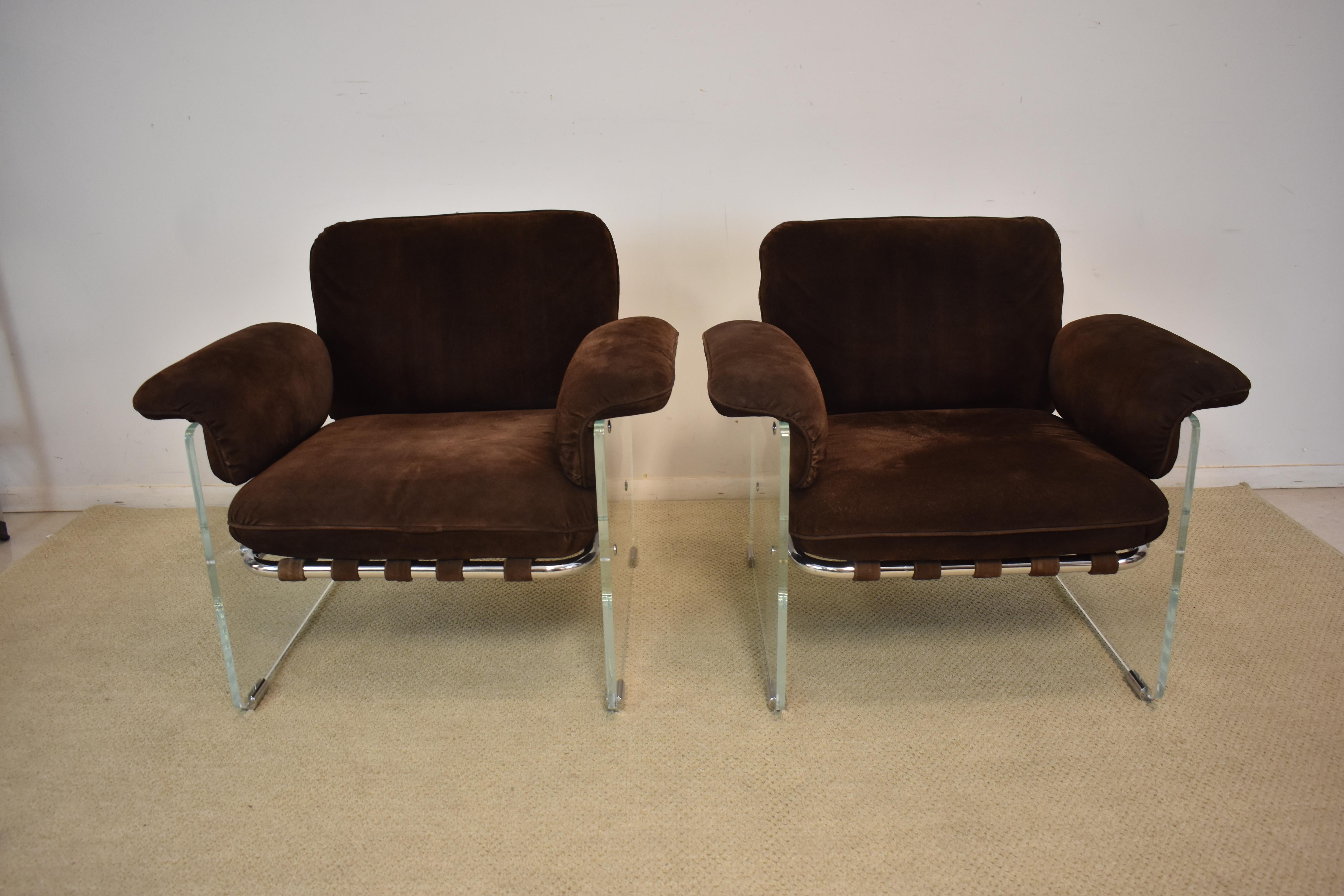 A pair of Pace Argenta lounge / club chairs. The side panels are Lucite and have chrome cylindrical base bumpers while the framing is tubular chrome. The backs and bottoms have bands holding the cushions in place. The fold-over arms are wing-like