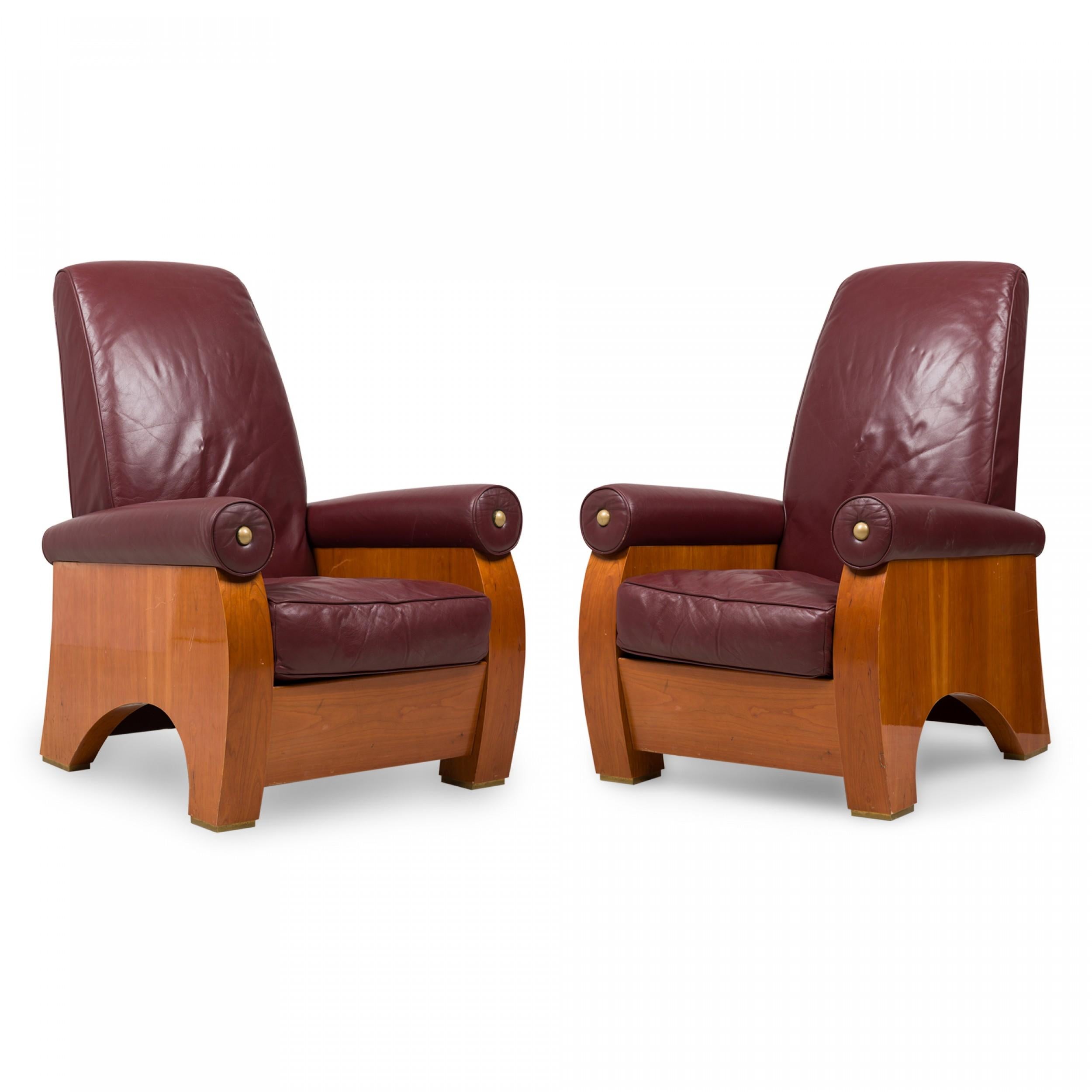 Pair of midcentury American high back mahogany armchairs upholstered in burgundy red leather with rolled arms, brass caps, arched feet and a cut out profile. (Pace Collection) (PRICED AS PAIR).