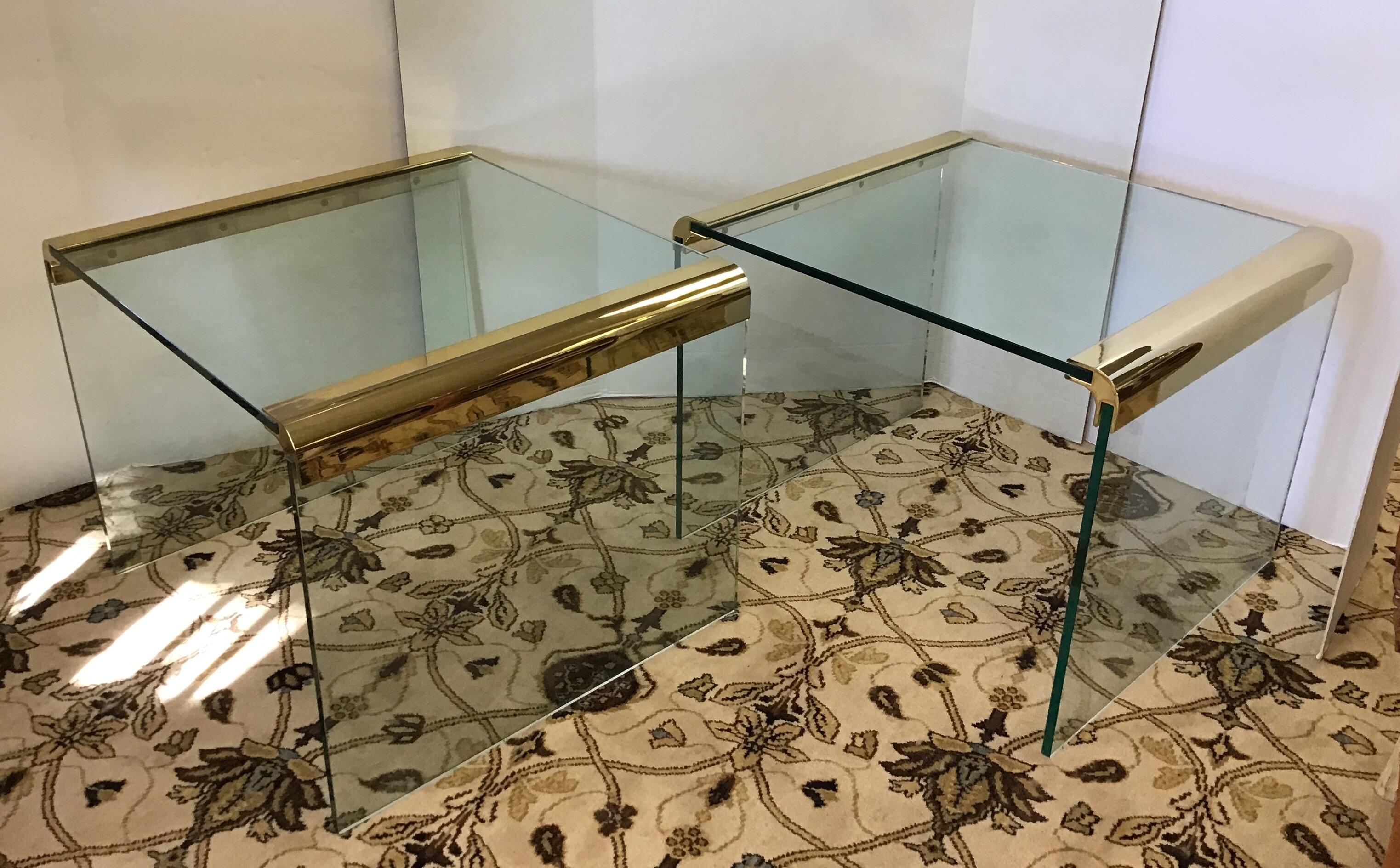 Pair of modern end tables in glass and brass with the simple yet elegant look that is a Pace Furniture staple; designed by Leon Rosen. Features rounded brass corners and three pieces of thick 1/2 inch glass.