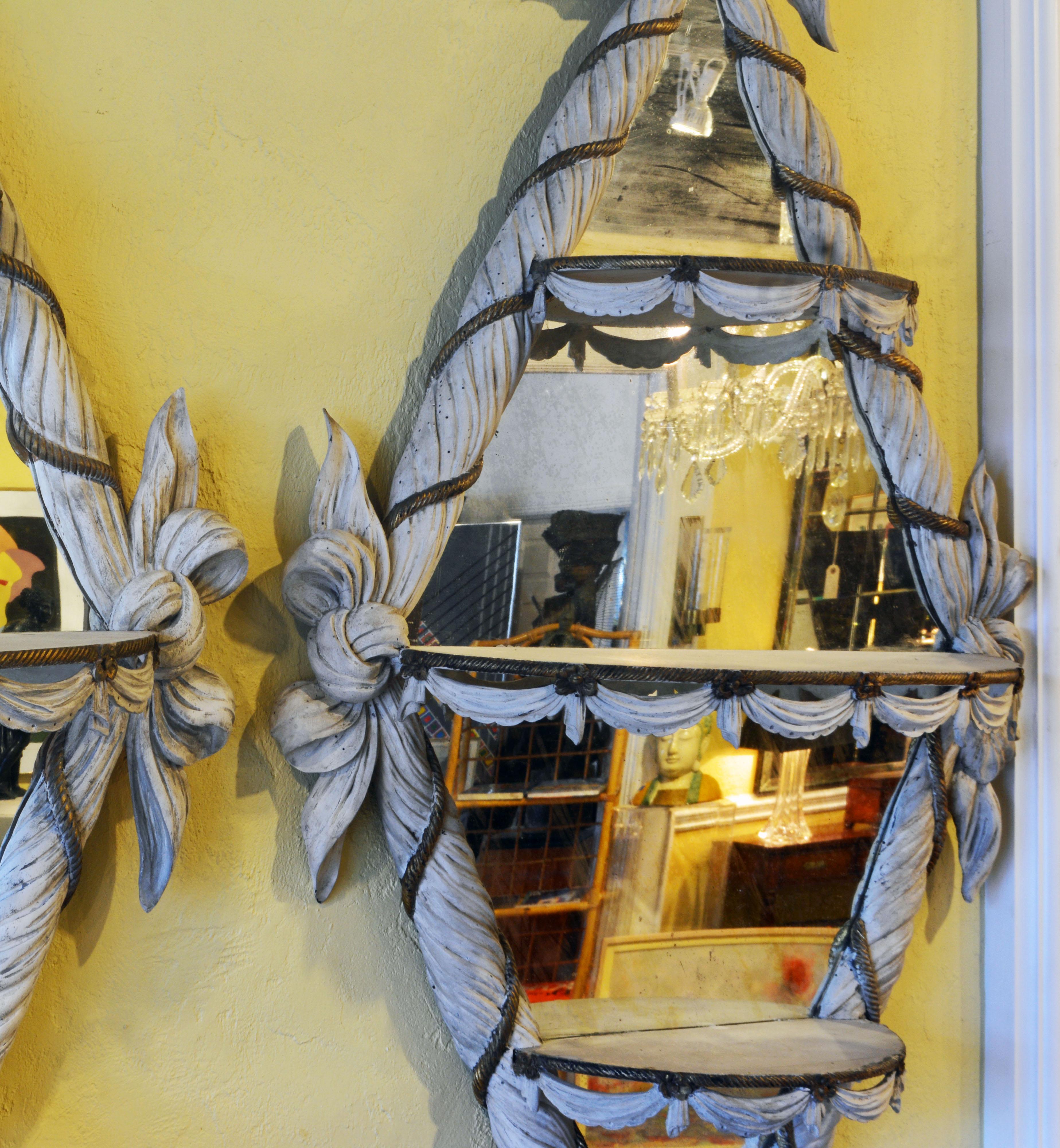These wonderfully different likely Italian late 19th century diamond shape mirrors sit in whitish washed frames carved like a twisted scarf with tied bows at the points and intertwined with a giltwood rope. What make them so attractive are the three