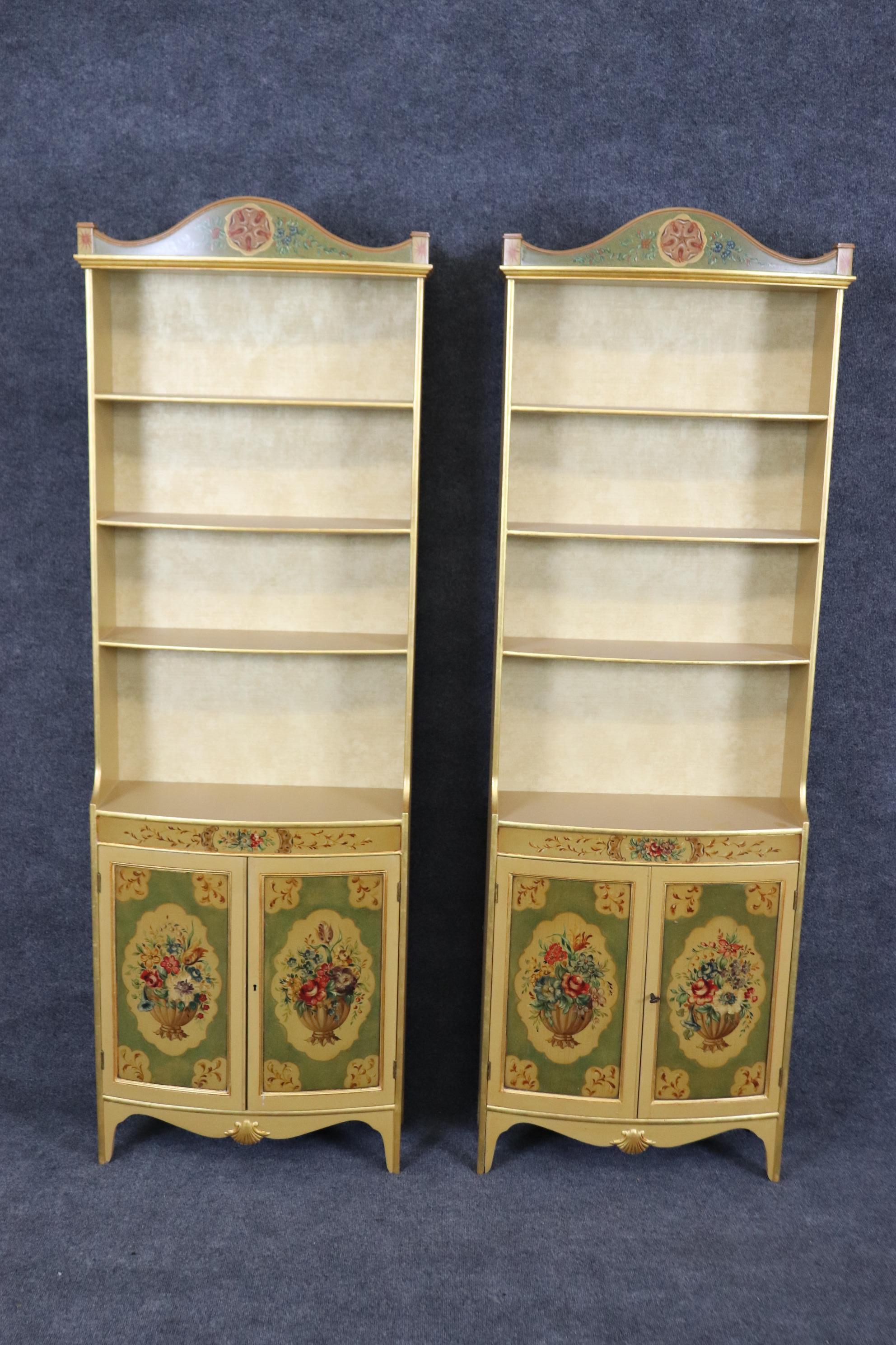 This is a gorgeous pair of Shaw Furniture Company bookcases with open top sections and closed bases. The cabinets are hand-painted in a Venetian style with genuine gold leaf gilded trim. They are in good condition. Measures a very shallow 8.25