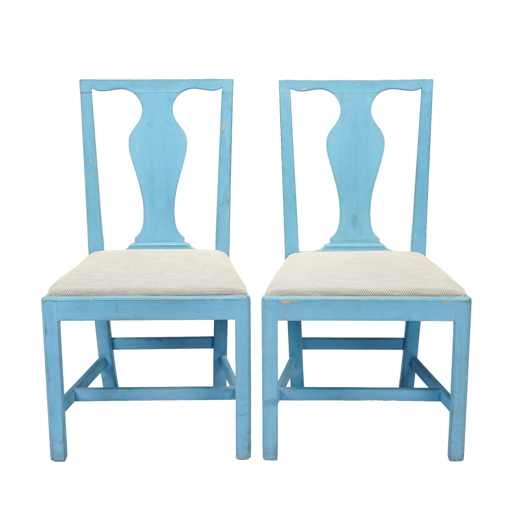Pair of Academic Revival mahogany slip seat side chairs in a blue milk paint after an 18th century Virginia model. The chairs feature a solid splat, a straight horizontal crest rail, and newly reupholstered seats.
American, circa 1940.