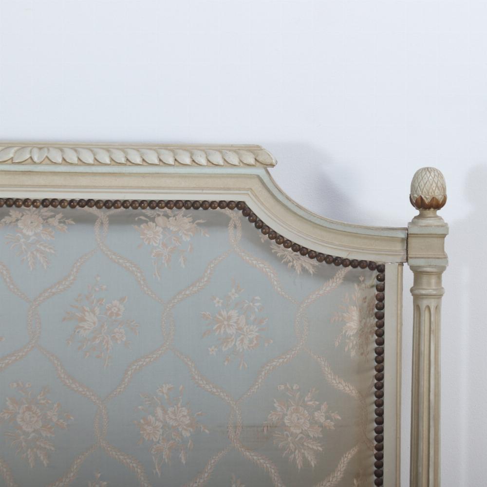 Pair of painted and carved French Louis XVI style upholstered twin beds C 1930. The wood frames having cream paint with pale blue accents and carved acanthus leaf decoration. Interior dimensions are : 36.25