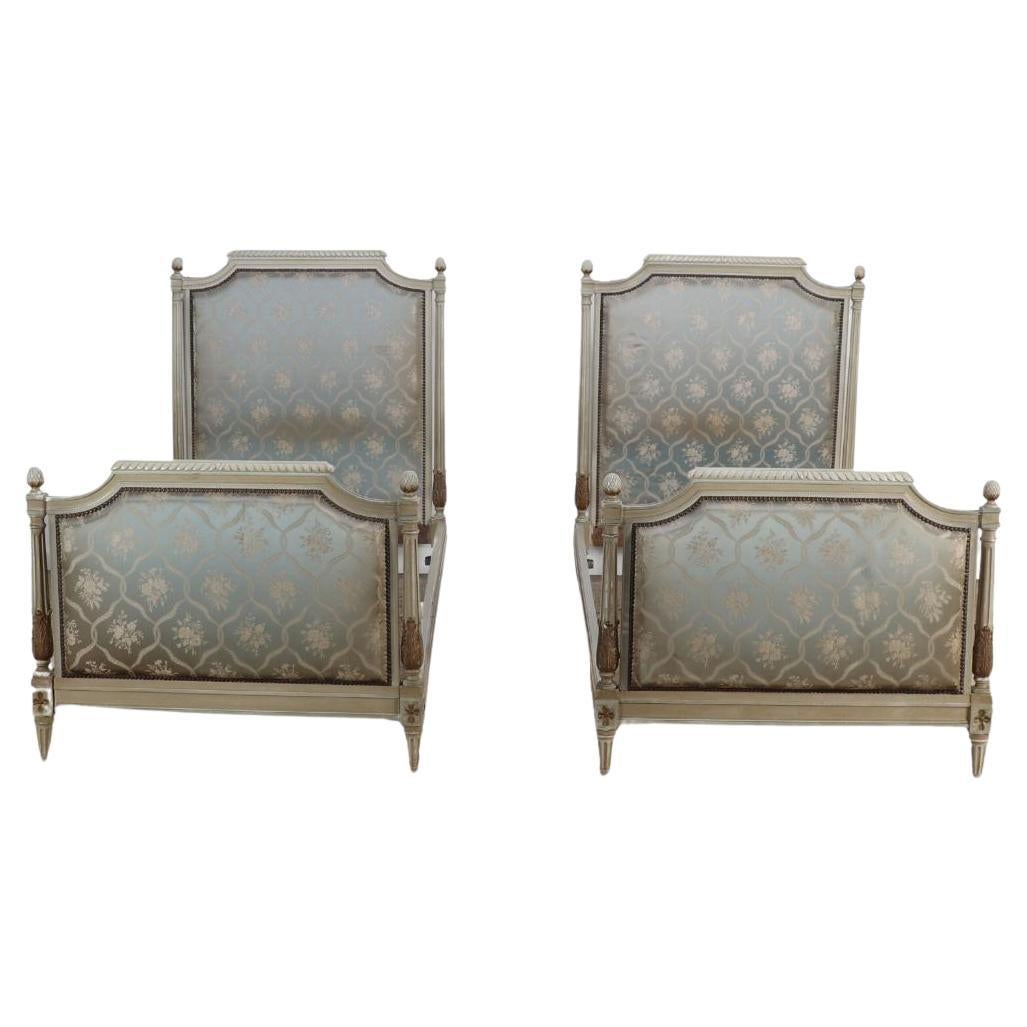 Pair of painted and carved French Louis XVI style upholstered twin beds C 1930. For Sale
