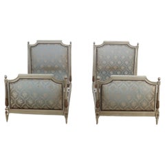 Vintage Pair of painted and carved French Louis XVI style upholstered twin beds C 1930.