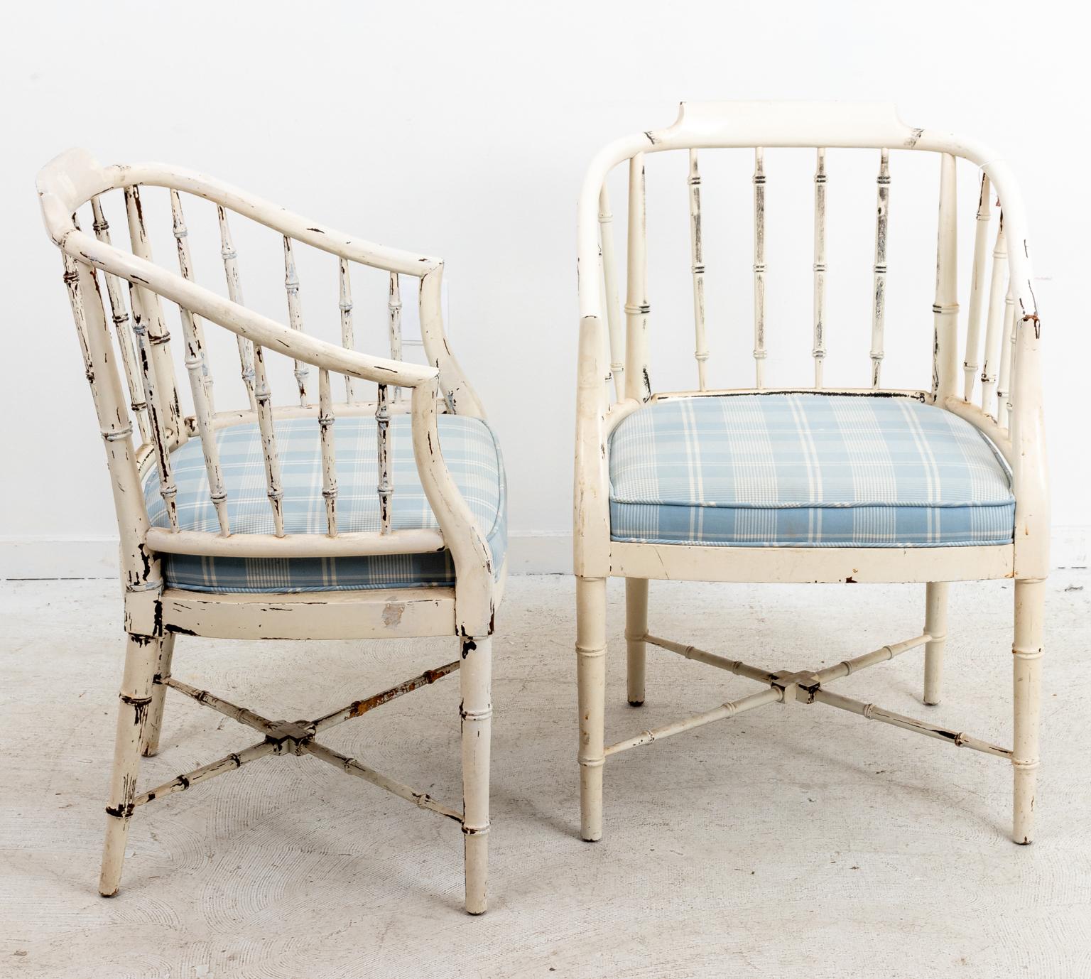 Pair of painted and decorated faux bamboo armchairs with vertical slat back and bottom X-shaped stretcher. The chairs also come with upholstered seats and paint in an distressed finish. Please note of wear consistent with age.
