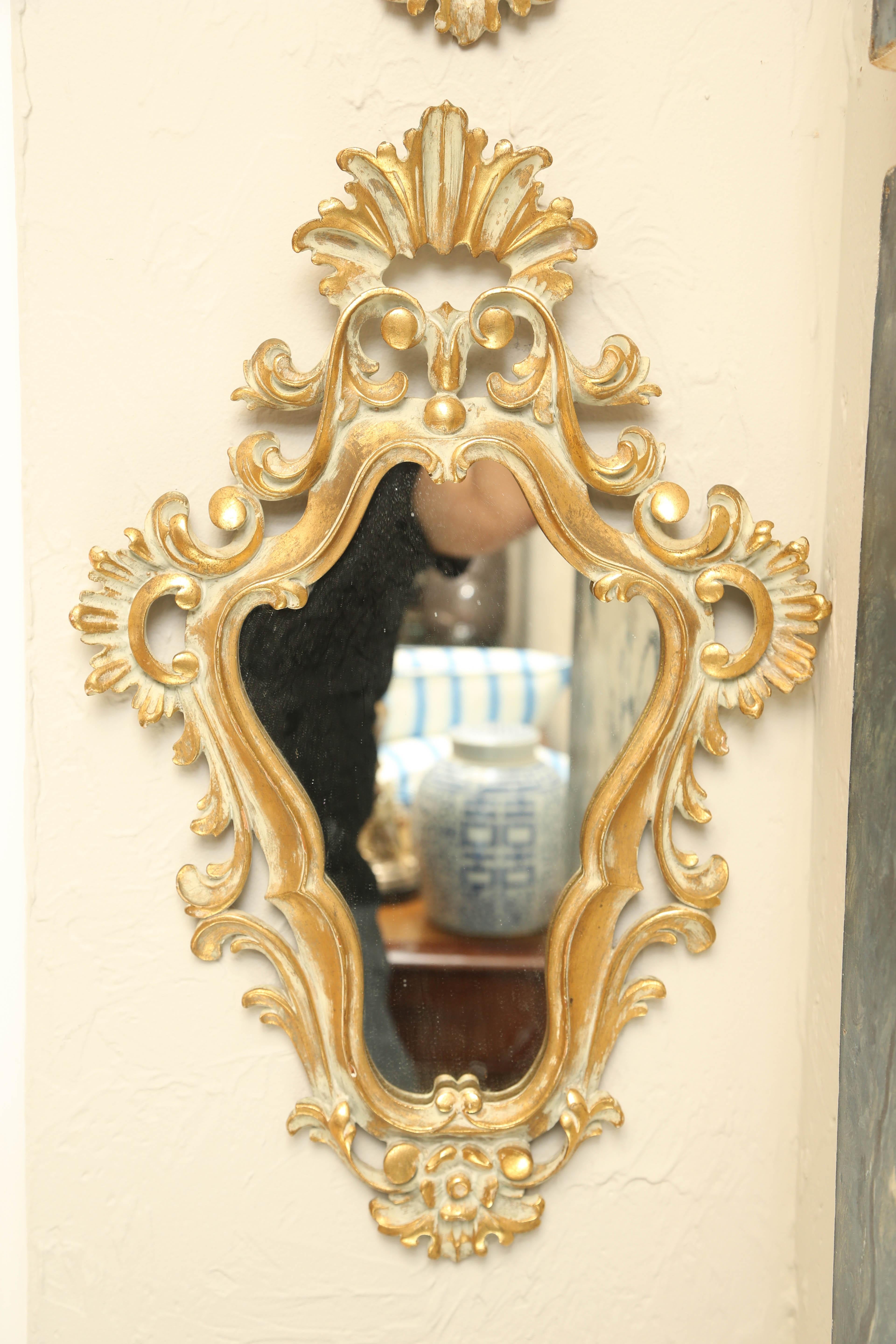 Pair of carved, painted and gilded Rococo style mirrors.