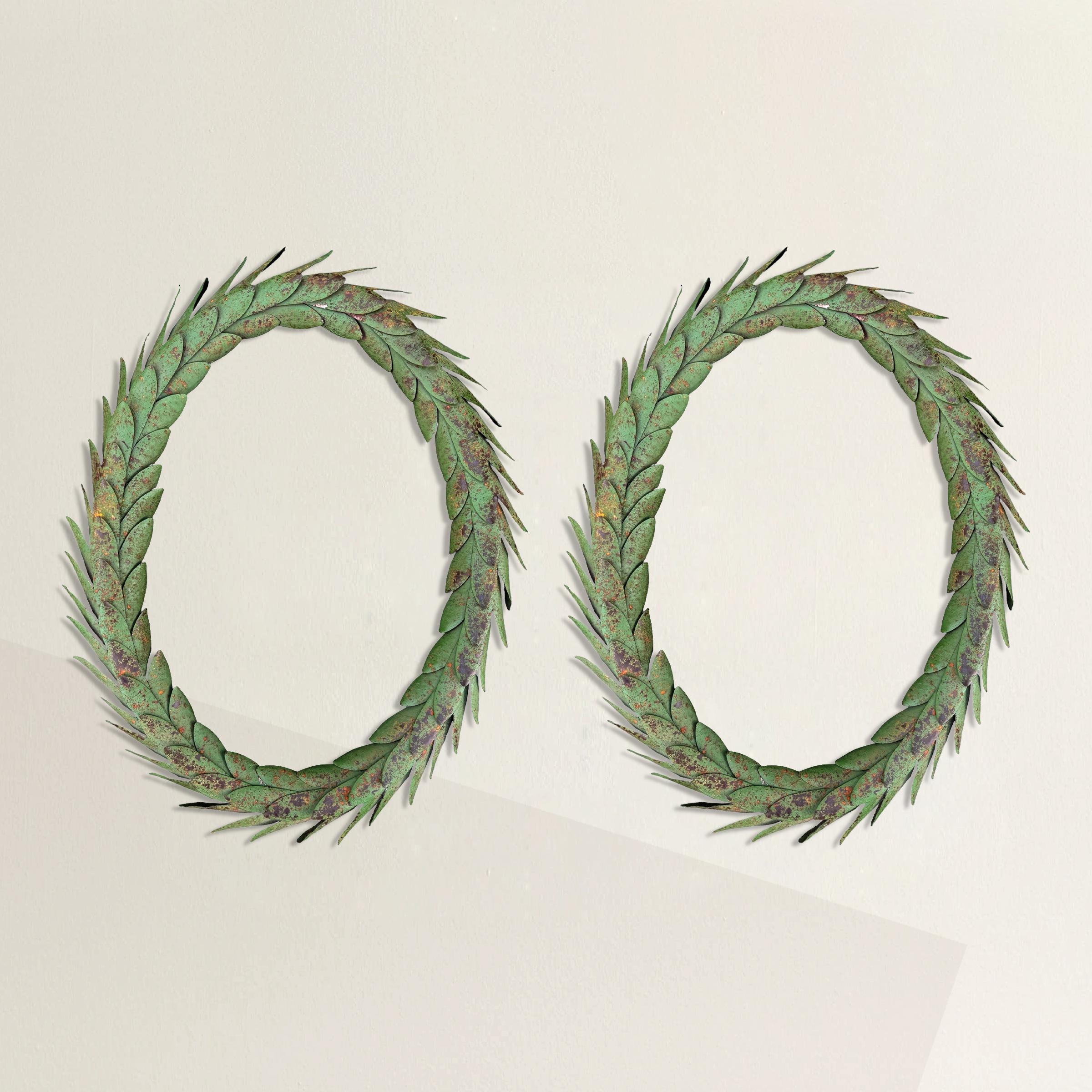 This exquisite pair of 20th-century tole laurel wreaths marries classical Greek motifs with timeless elegance. Each wreath features meticulously crafted green-painted and gilt leaves, arranged into large, graceful ovals. The craftsmanship and
