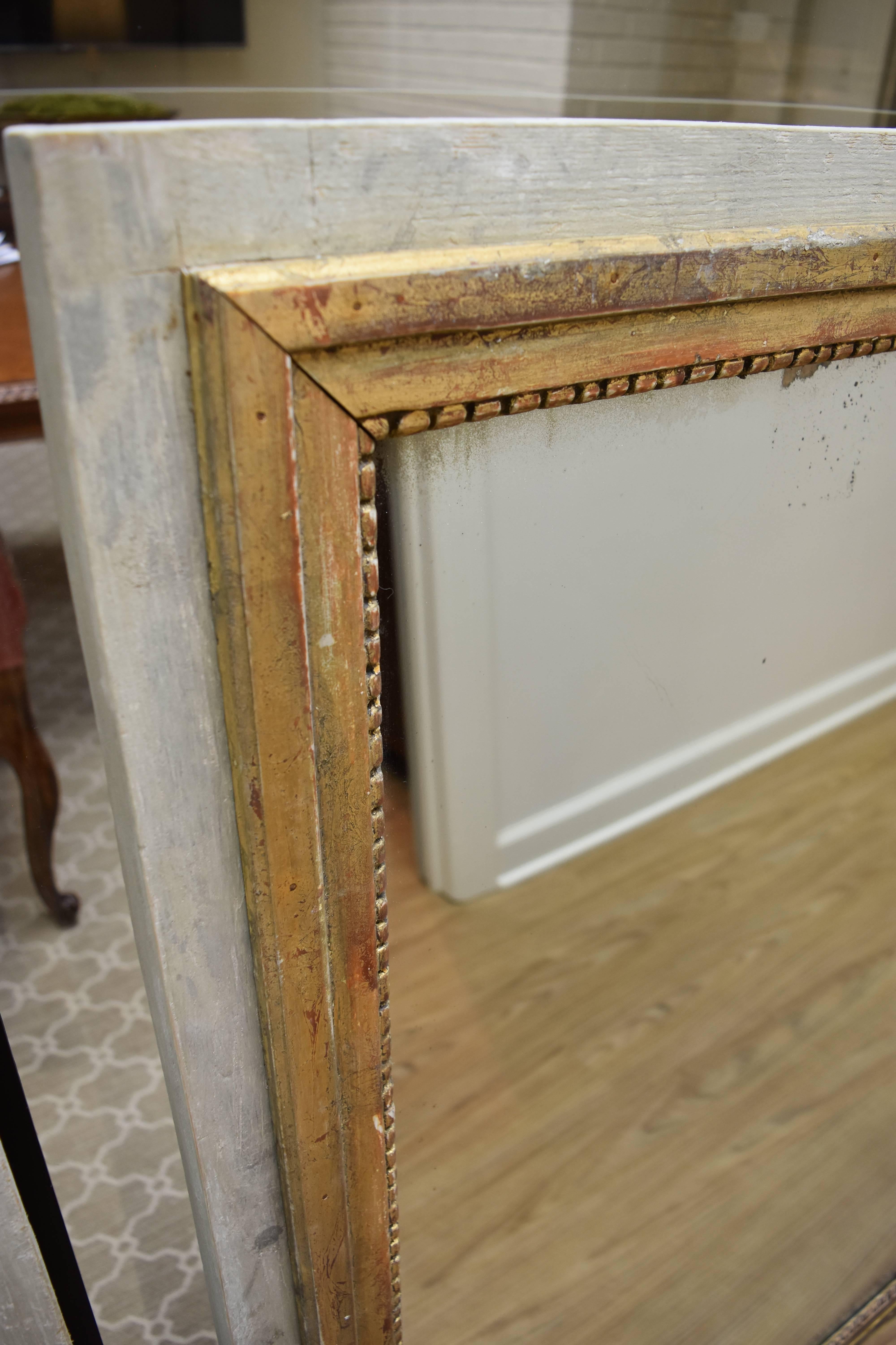 This pair of painted and giltwood mirrors is from the South of France. And while the mirrors are newly constructed, the frames and mirror backs are made entirely of 19th century wood. The plate glass is old with minor distressing and age. The finish