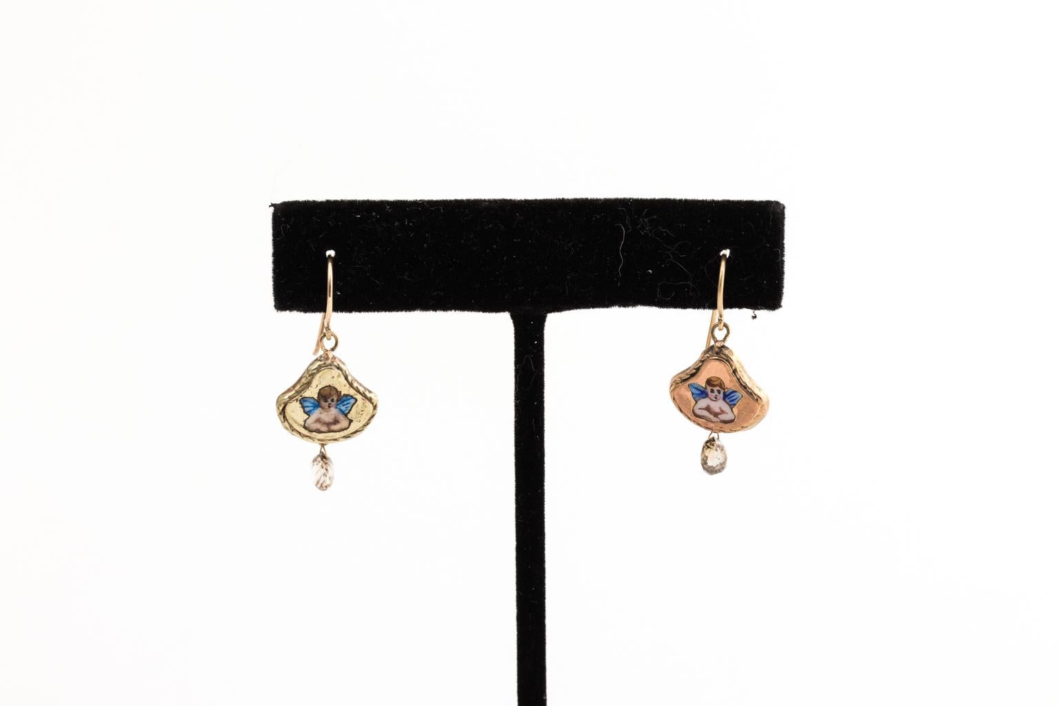 Circa early 1900s pair of mismatched Enamel painted Angel earrings in 14 karat pink gold and 14 karat yellow gold. Each earring has approximately 0.45 carats of champagne diamonds briolette drops. Hand crafted out of antique materials.
