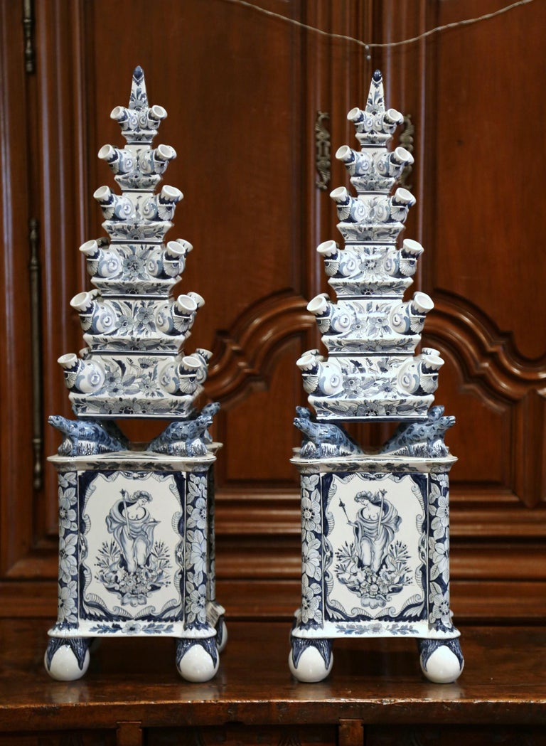 Important pair of ceramic Tulipieres (or tulip pagodas) from Mottahedeh and Company, New York. Built in seven pieces and shaped as tall cones with holes for tulips, the decorative vases are hand painted in the white and blue palette, embellished