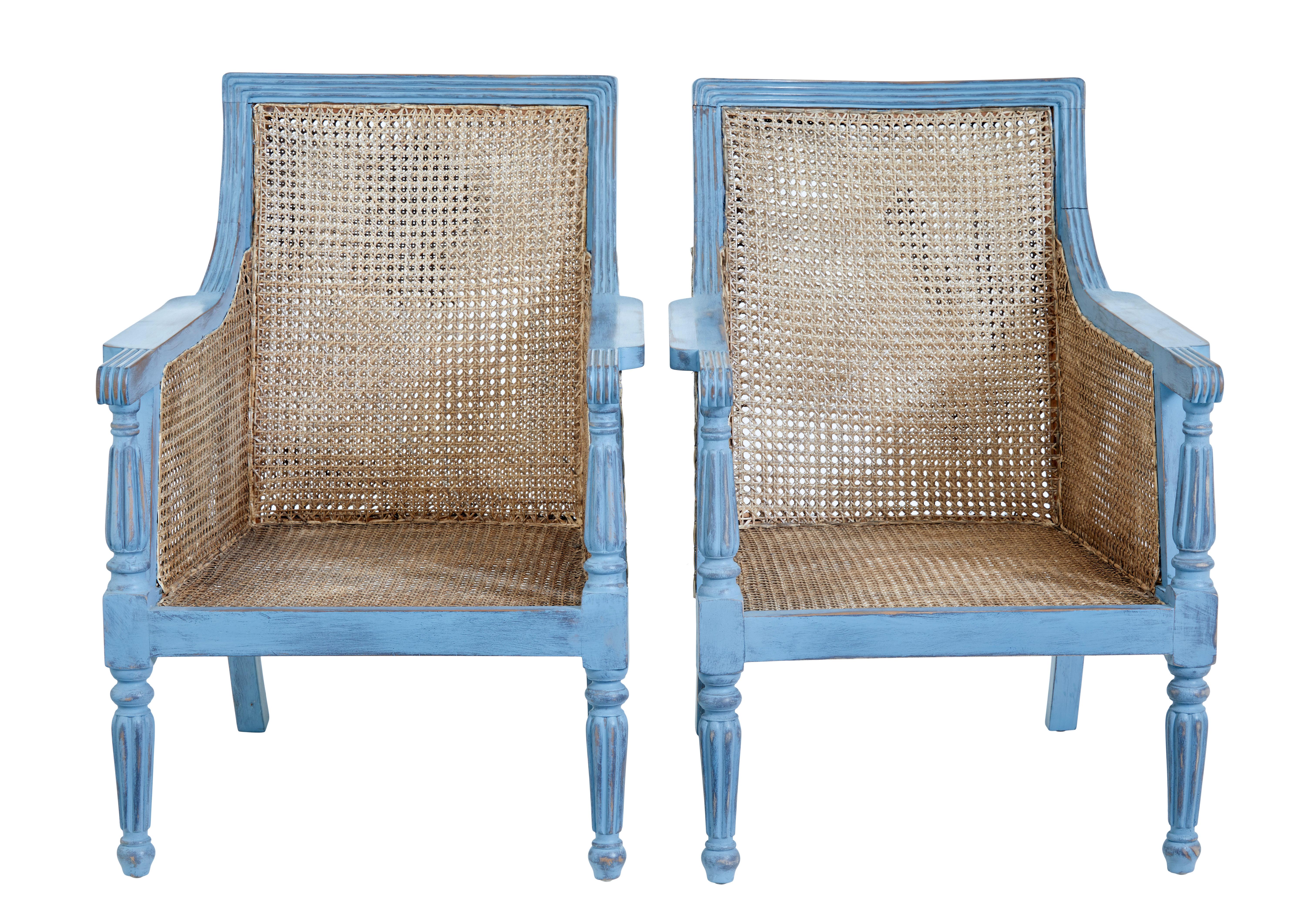 Pair of painted cane work bergere armchairs circa 1990.

Good quality pair of bergere armchairs ready to have some cushions made for them.  Solid mahogany frames finished in a distressed blue paint.

Double wall cane work to backs and sides, cane