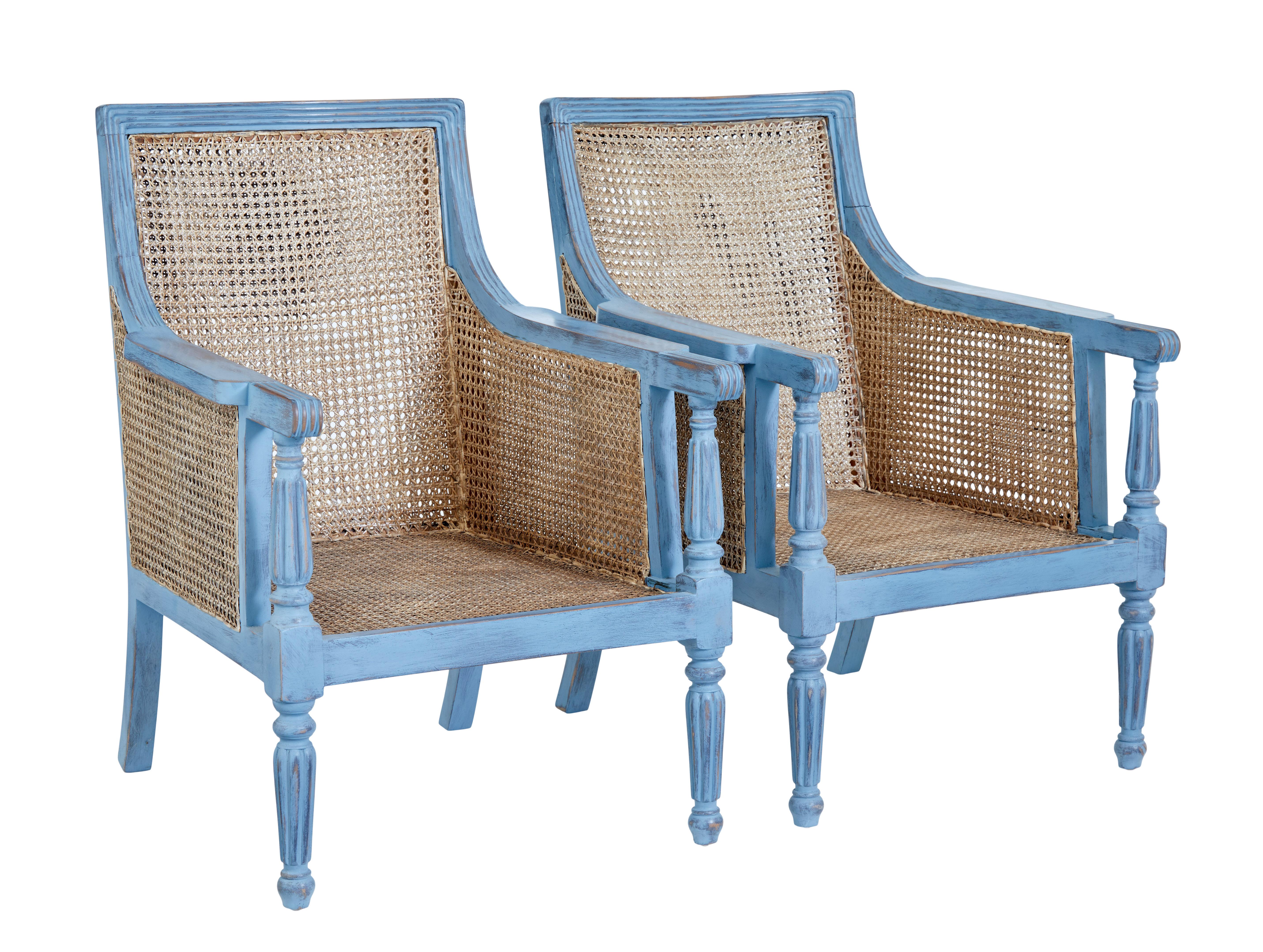 Pair of painted cane work bergere armchairs circa 1990.

Good quality pair of bergere armchairs with brand new padded seat and back rest cushions. Solid mahogany frames finished in a distressed blue paint.

Upholstered in a light biege fabric