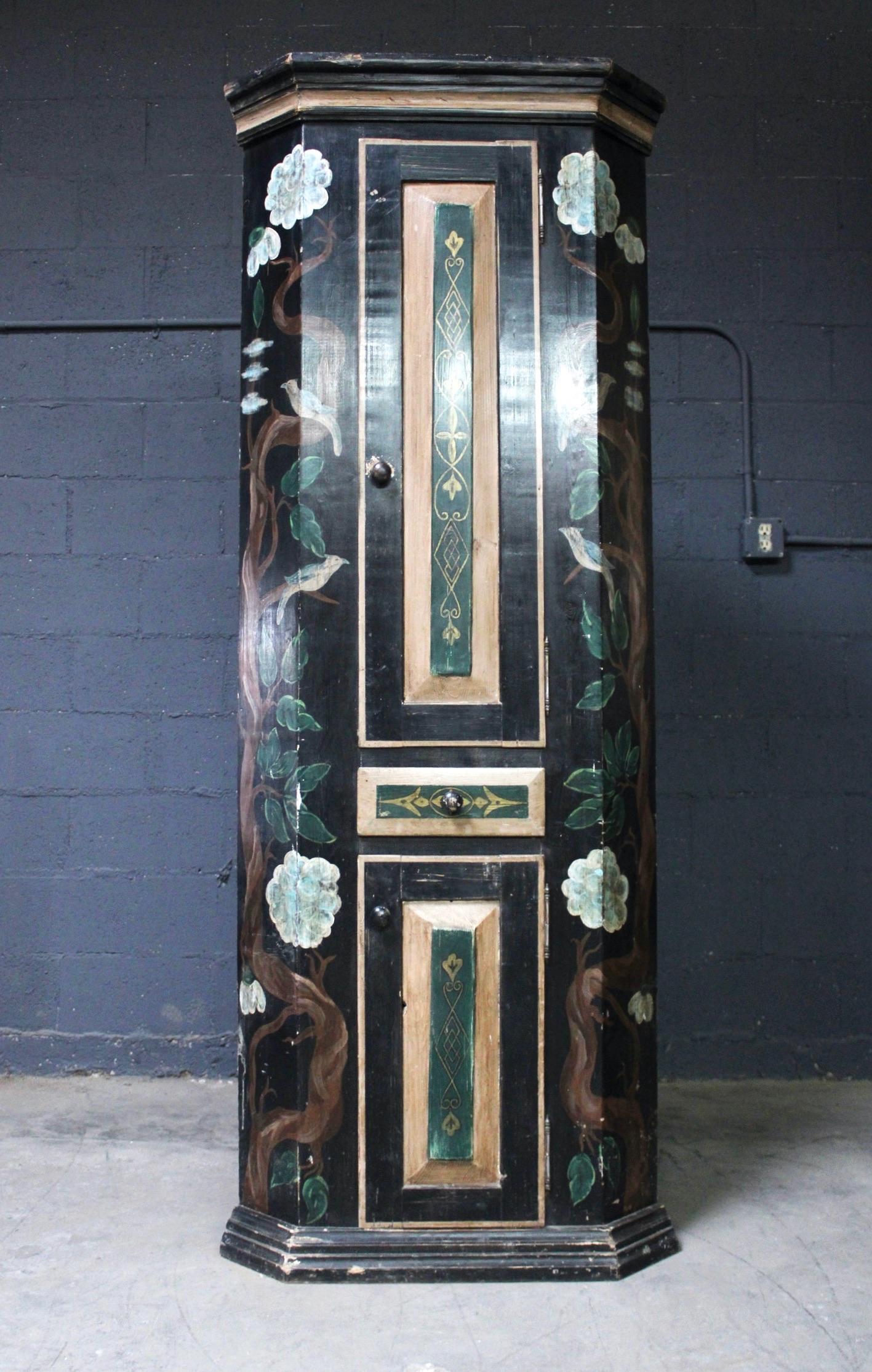 Mid-19th century style pair of reproduction corner cabinets with two doors and a drawer. 

These pained cabinets were made from pieces of antique pine furniture in Latvia.