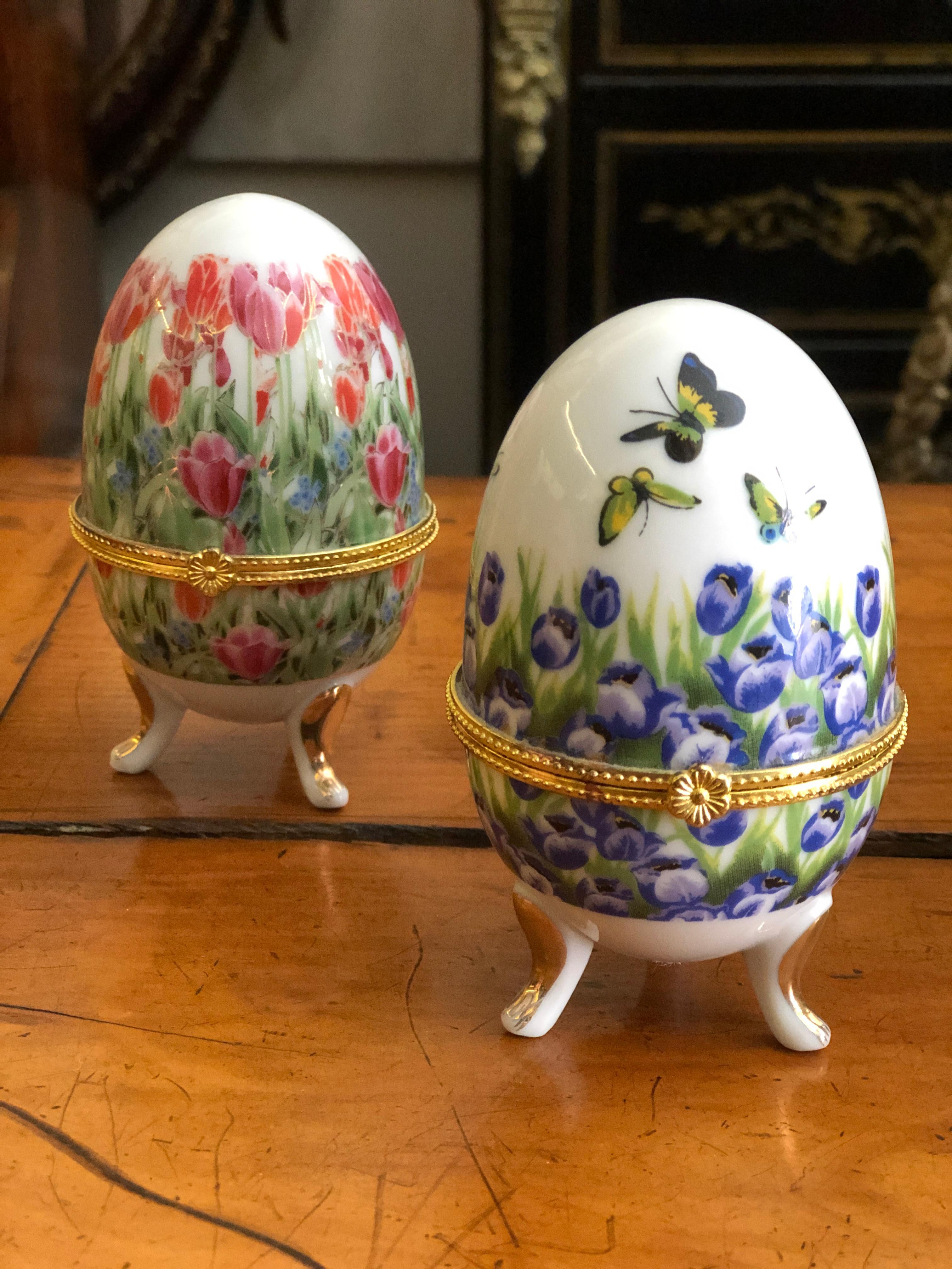 Pair of small painted ceramic egg boxes raised on tripod legs.
France, circa 2000.