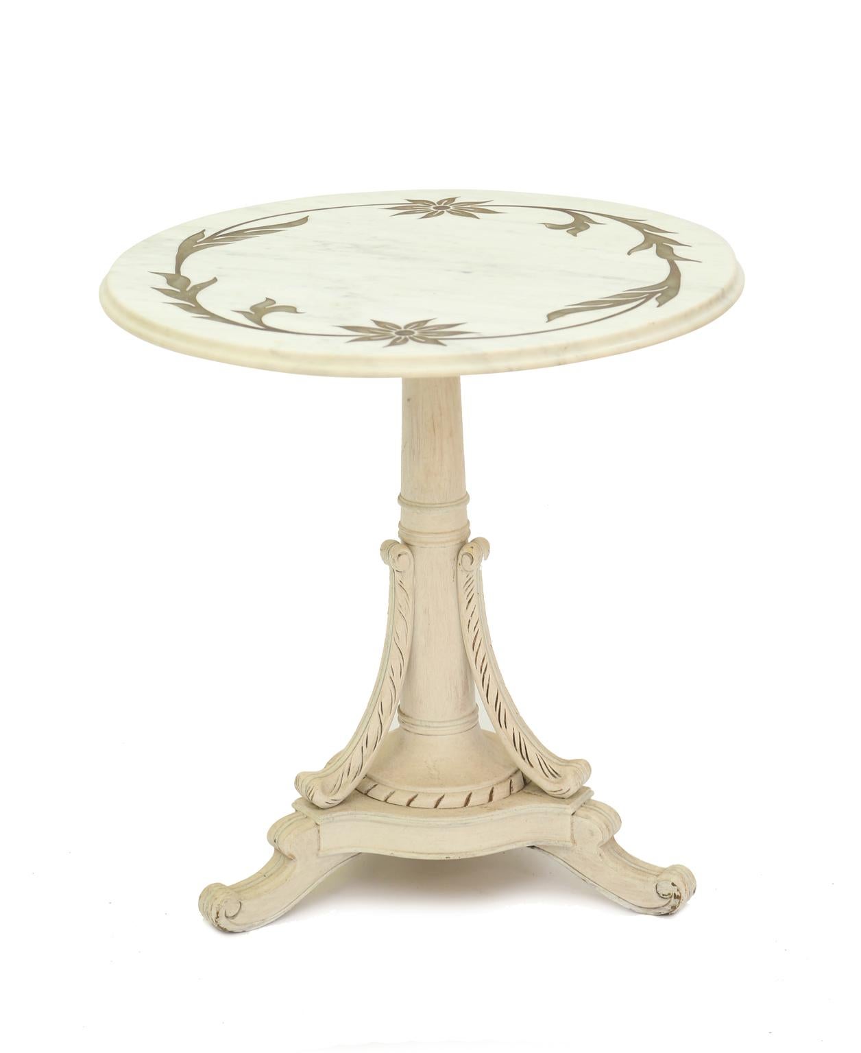 Pair of end tables, each having a round top of marble, with foliate and floral motifs of inlaid bronze, raised on painted pedestal base of a tapering column flanked by three C-scrolls, on tripartite base with concave sides, ending in splayed