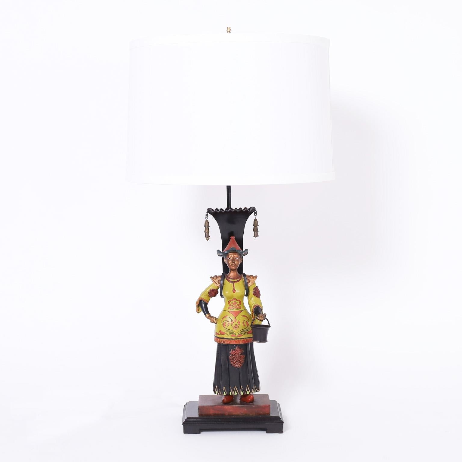 Transporting pair of chinoiserie table lamps by Jeanne Reed's LTD, crafted in cast bronze and painted, depicting Asian figures of a man and woman.