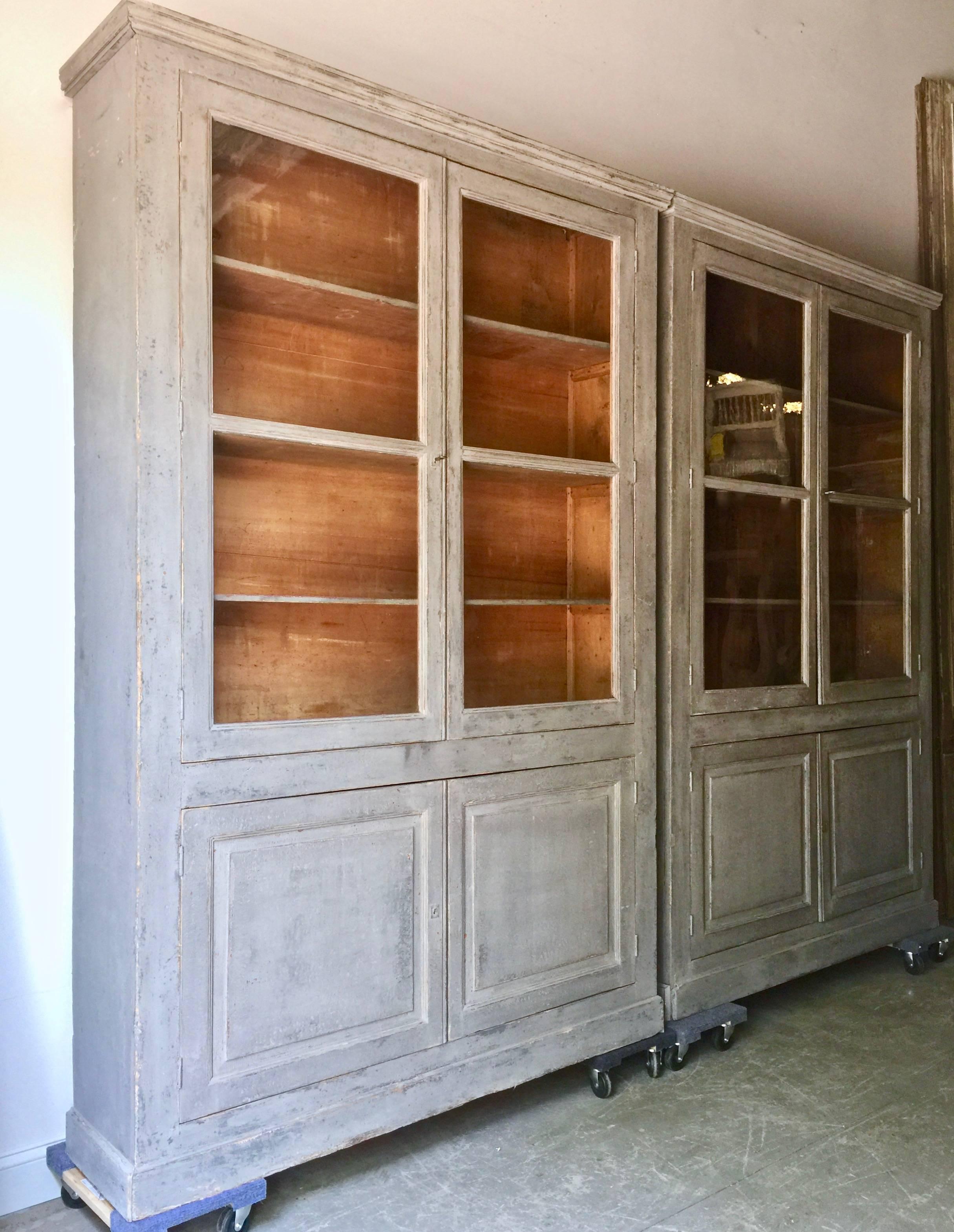 A pair of very large 19th century painted Bibliothèques from France. The glazed top panels have their most original glasses and the bases are with fielded panels. Inside four fixed shelves. Very simple, handsome library bookcases.
Here are few