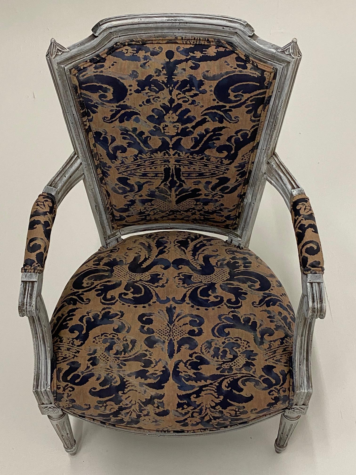 Superb pair of French vintage fauteuil armchairs having painted carved wood frames and wonderful Fortuny upholstery. Arm height 25