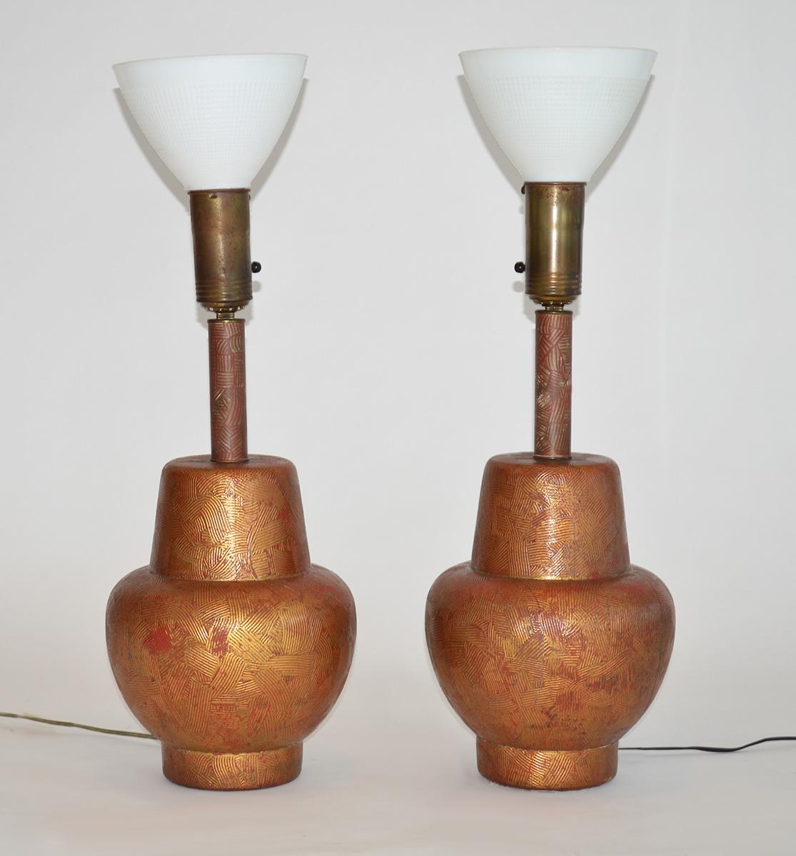 Pair of Lamps by James Mont in Painted Gilded Wood 
A pair of bulbous form Asian red painted and gold gilt over wood table lamps with original glass shades and linen shades. Some chips and loss to paint and gilt, need re wiring. 