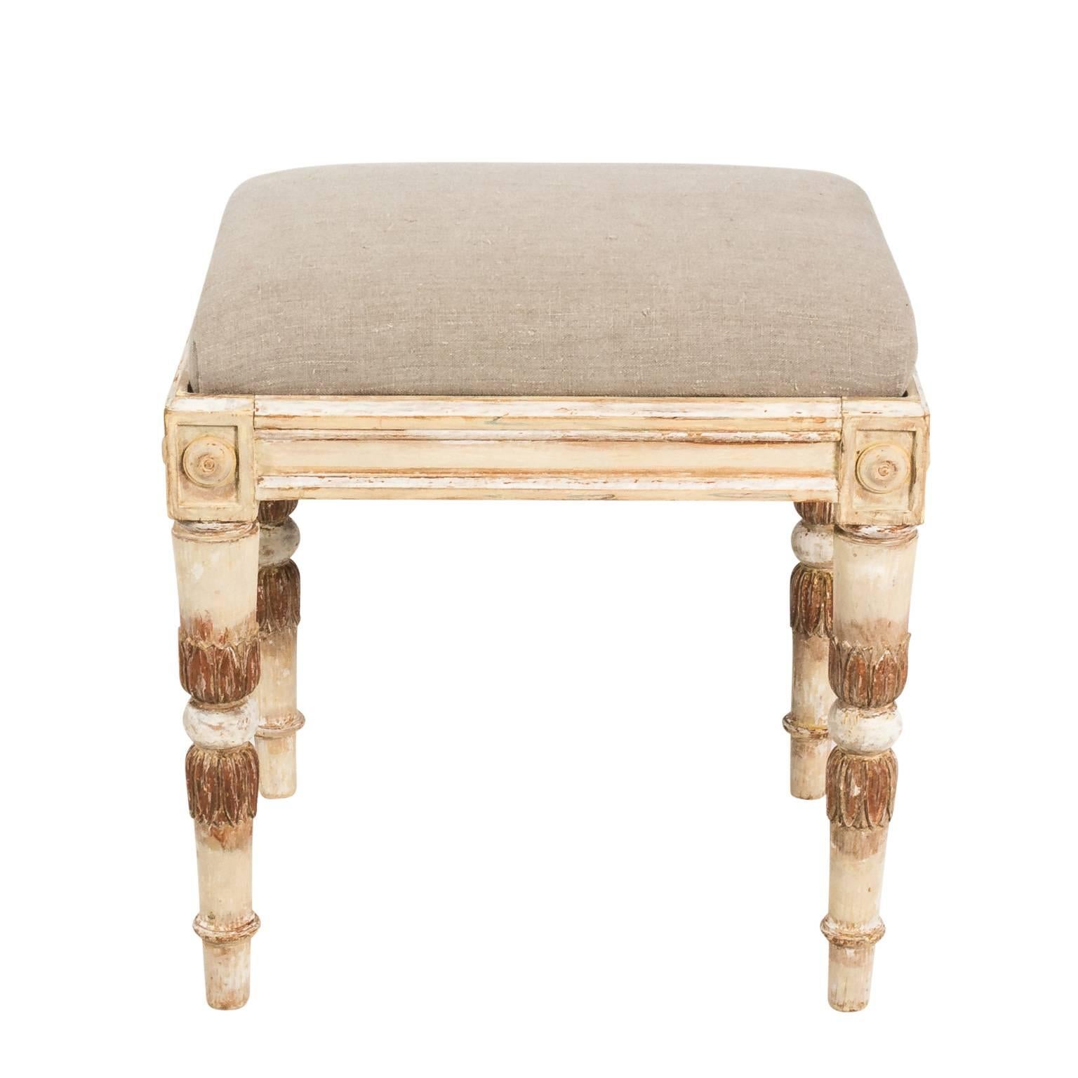 Pair of Gustavian style painted benches in a partially gilded finish with upholstered seats, circa early 20th century.
 