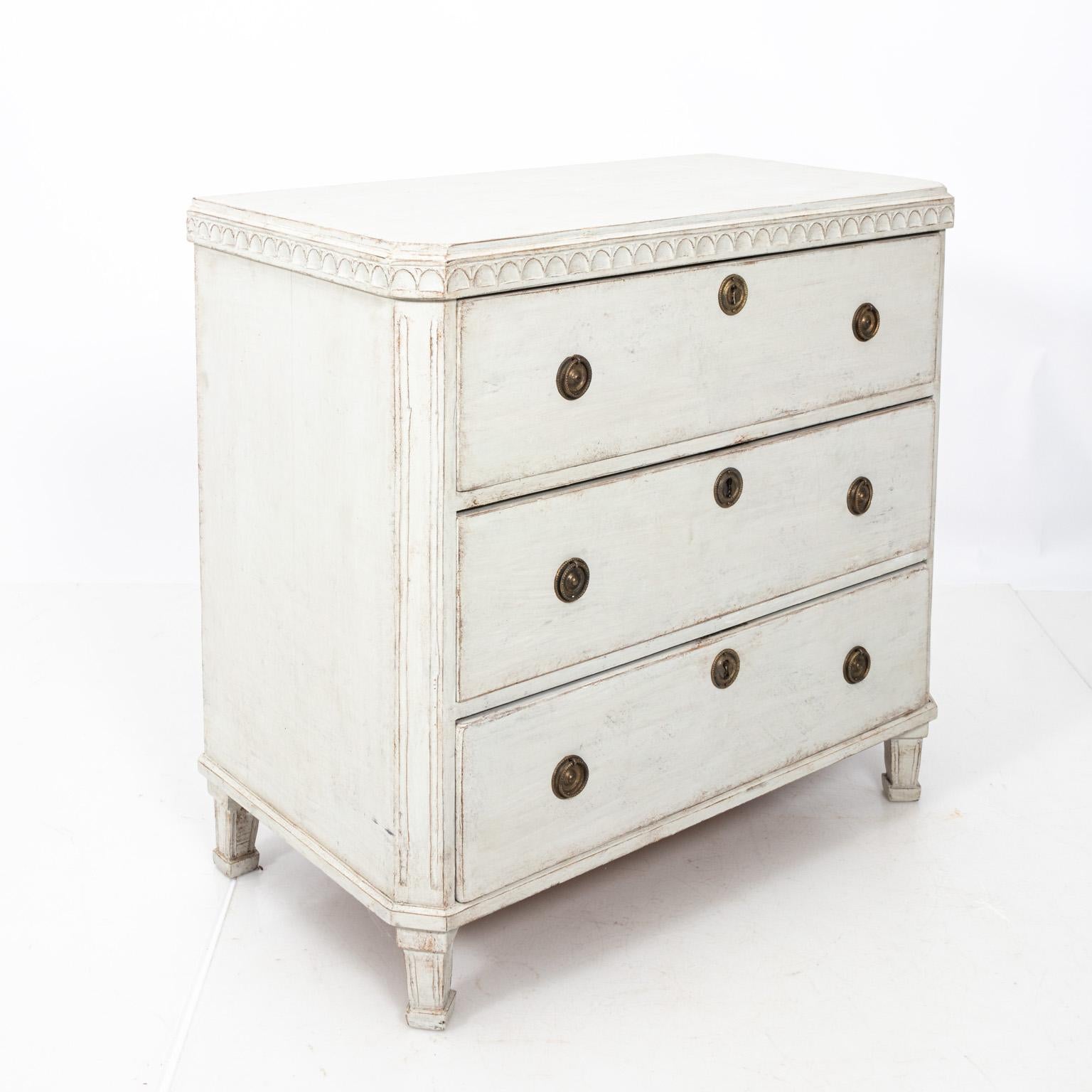 Pair of white painted Gustavian chest of drawers with metal hardware and historic paint that features original patina, circa 1880s. Please note of wear consistent with age including minor paint loss.