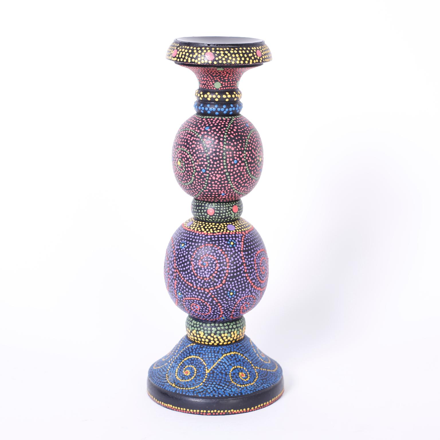 Whimsical pair of wood candle sticks with a Classic double bulb form and painted in a colorful pointillist technique giving the illusion of a micro mosaic.