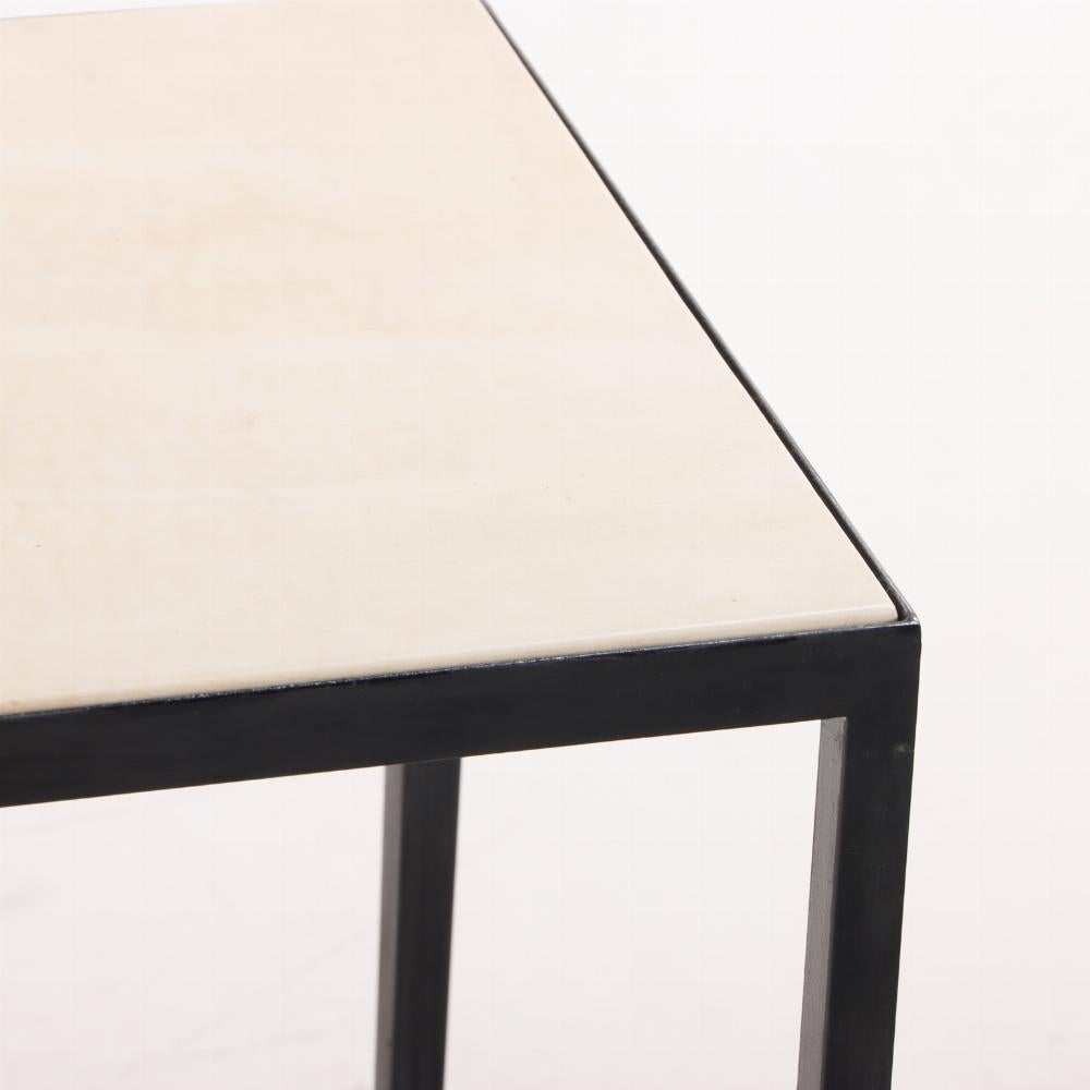 A single painted iron and parchment end table in the manner of Jean-Michel Frank. Contemporary. Pergamino 
Please inquire if you are interested in a set.
