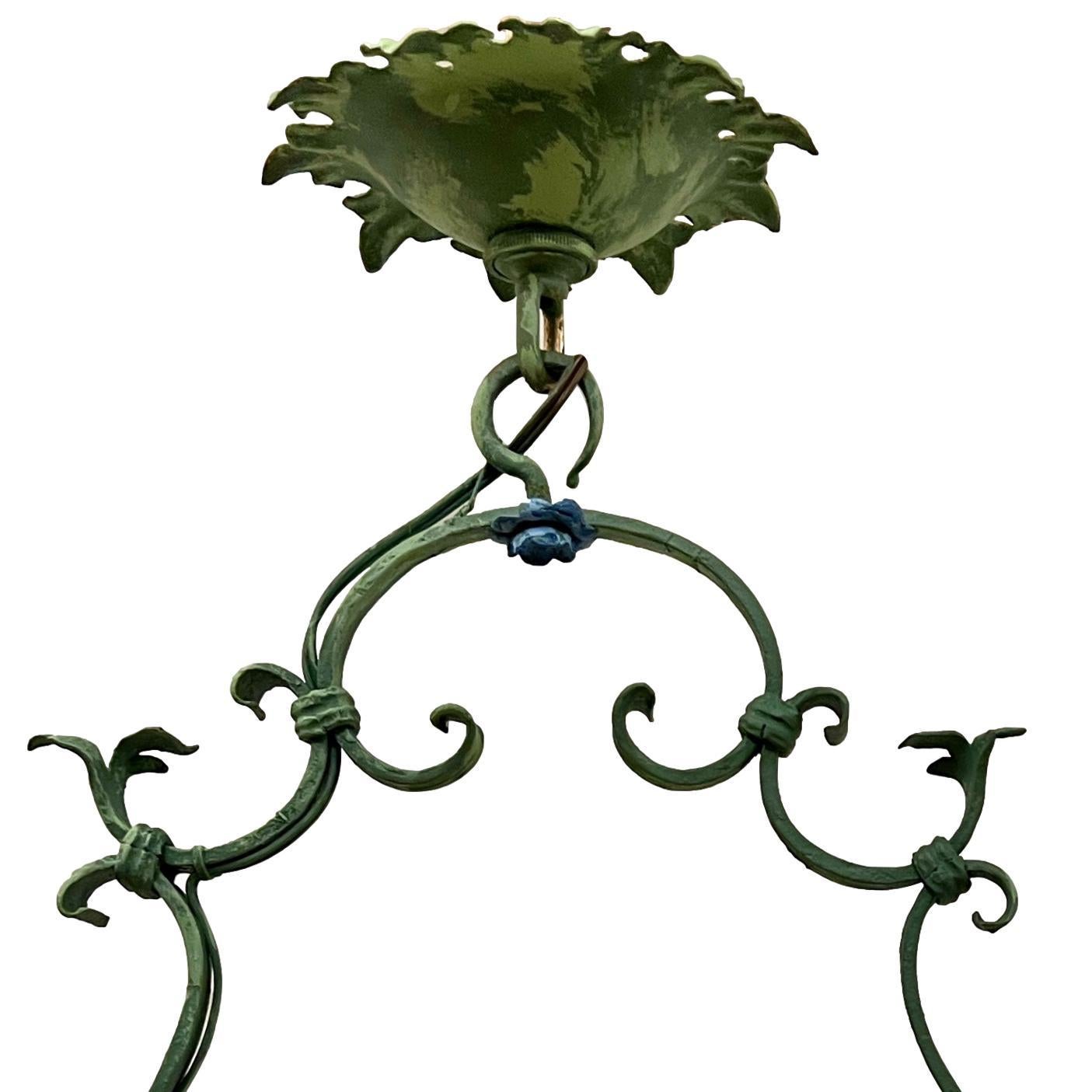 A pair of circa 1920's Italian single-light iron chandeliers with verdigris body with blue flowers. 
Sold individually.

Measurements:
Drop: 17