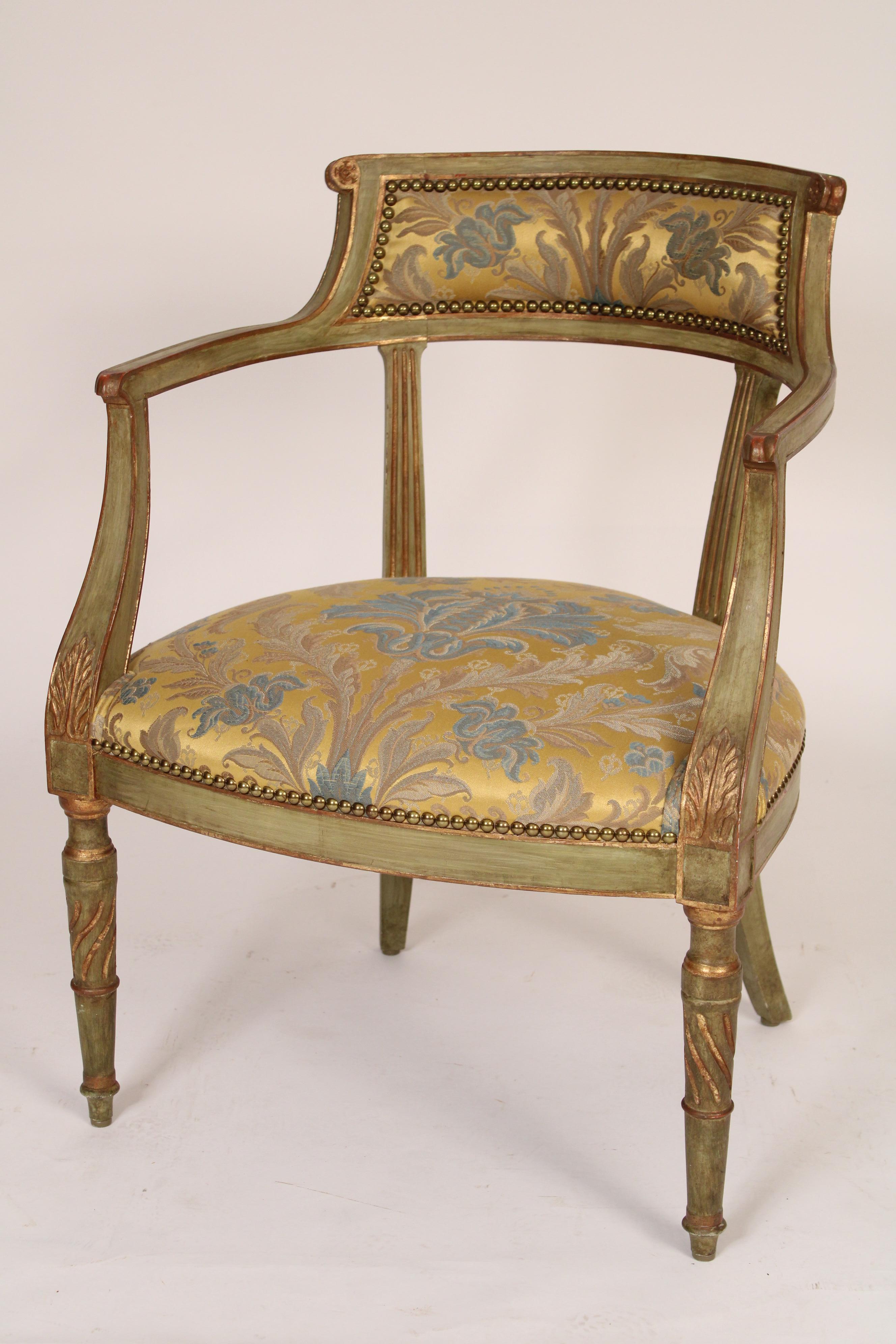 Pair of neo classical style painted and gilt decorated barrel back armchairs, late 20th century. With brass nail head upholstered backs, arms with down swept arm supports ending in acanthus leaf carvings and spiral turned tapered front legs. Deepest