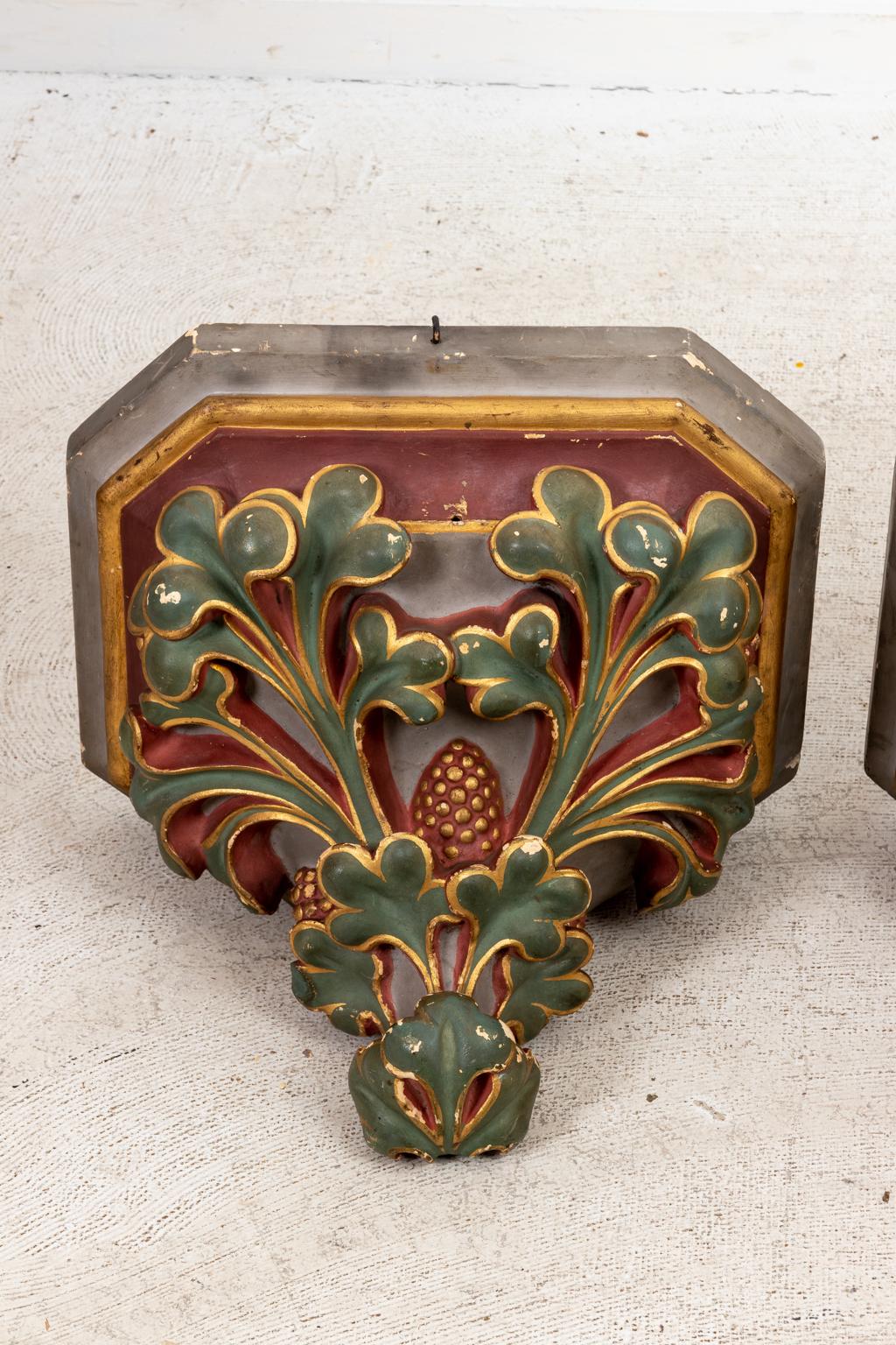 Circa 1900s pair of painted plaster corbel shelves detailed with green three leaf clover foliage and gold color trim on the base. Made in England. Please note of wear consistent with age including minor chips and finish loss throughout.