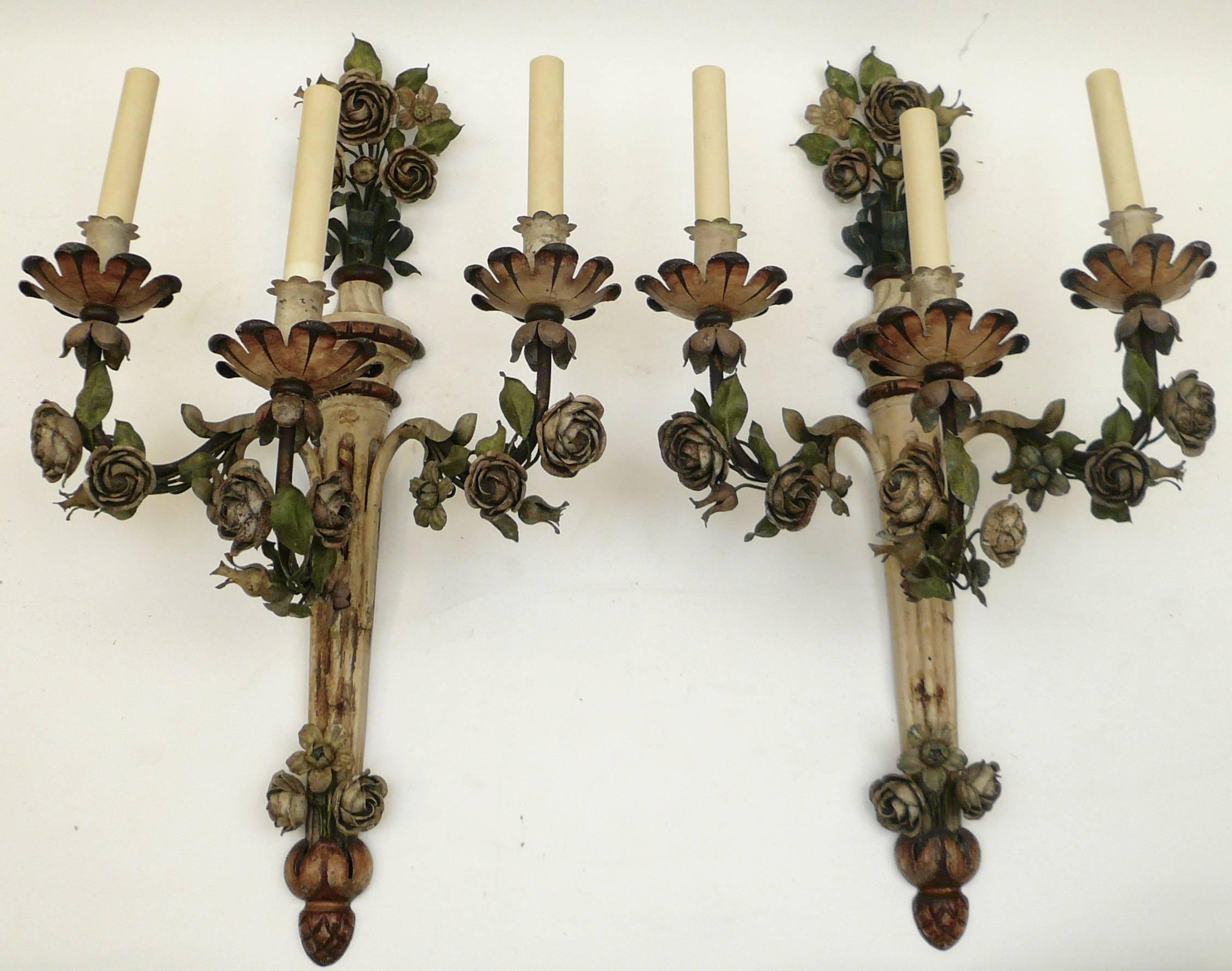 This handmade pair of Maison Jansen style tole sconces feature hand-painted flowers and foliage.