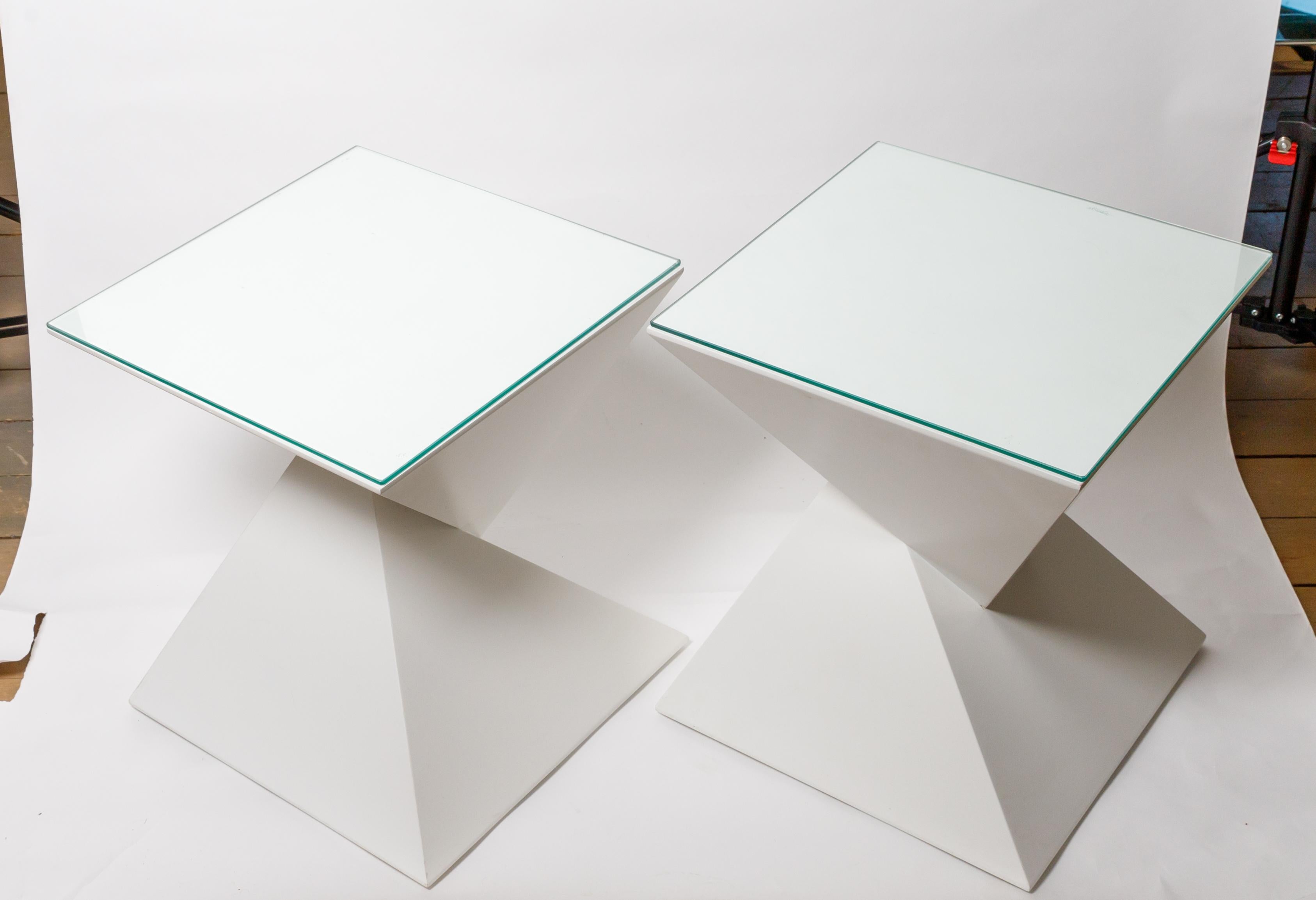 Pair of painted wood, angular, geometric side tables with glass tops.