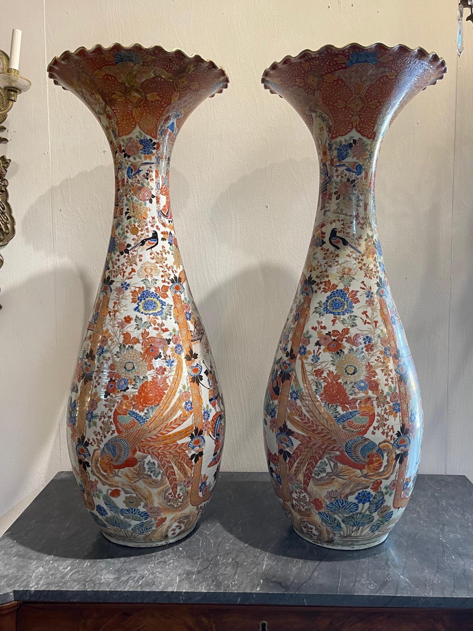 Exceptional large scale pair of palace size Japanese Imari vases. Beautiful colors featuring floral and Asian images. Fabulous!!