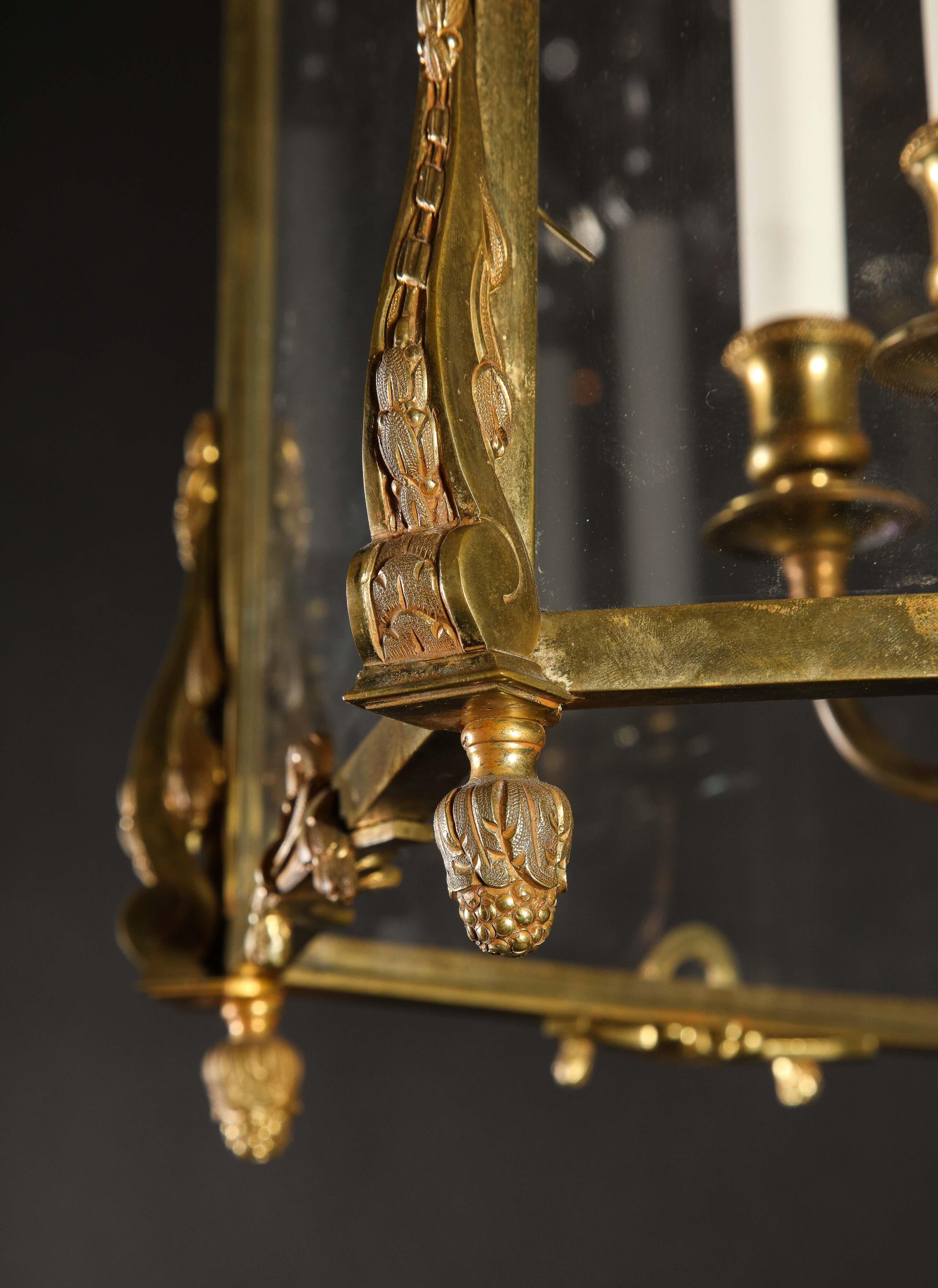 A Pair of Palatial superb French Louis XVI style gilt bronze multi light Lanterns of exquisite craftsmanship with glass panels and further embellished with unusual gilt bronze floral wreaths. Each lantern has interior gilt bronze arms.