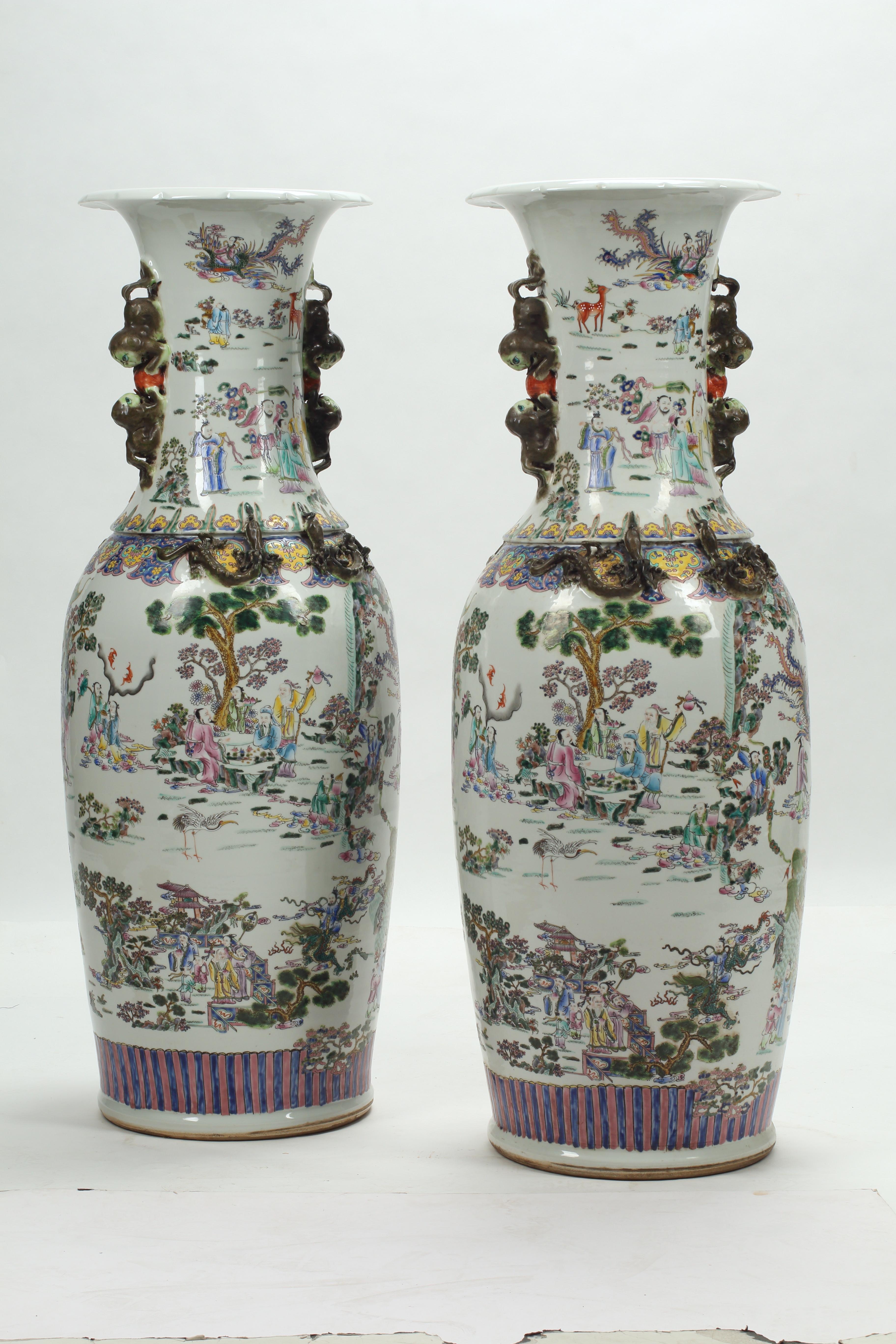 This palatial pair of hand-painted Chinese baluster shaped vases display the intricate and detailed craftsmanship of Chinese porcelain in a rare height measuring nearly 4 ft. tall each. The vases feature figural scenes of court gatherings surrounded