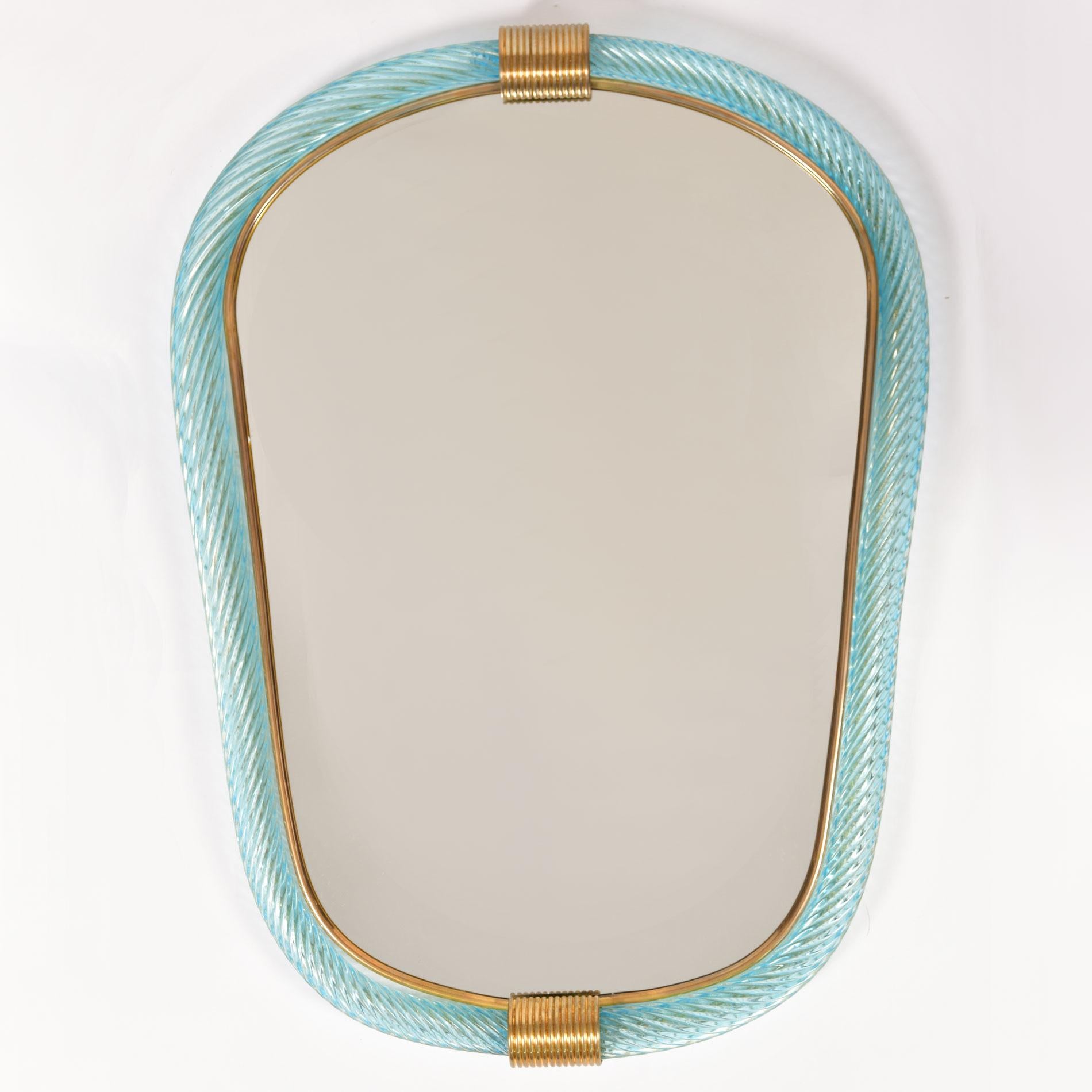 Pale green/blue ribbed hand blown Murano glass eliptical mirrors with two brass fluted clasps at the top and bottom, the inner edge lined with slender brass filet.

Also available in palest pink.

8 week lead-time if not in stock.