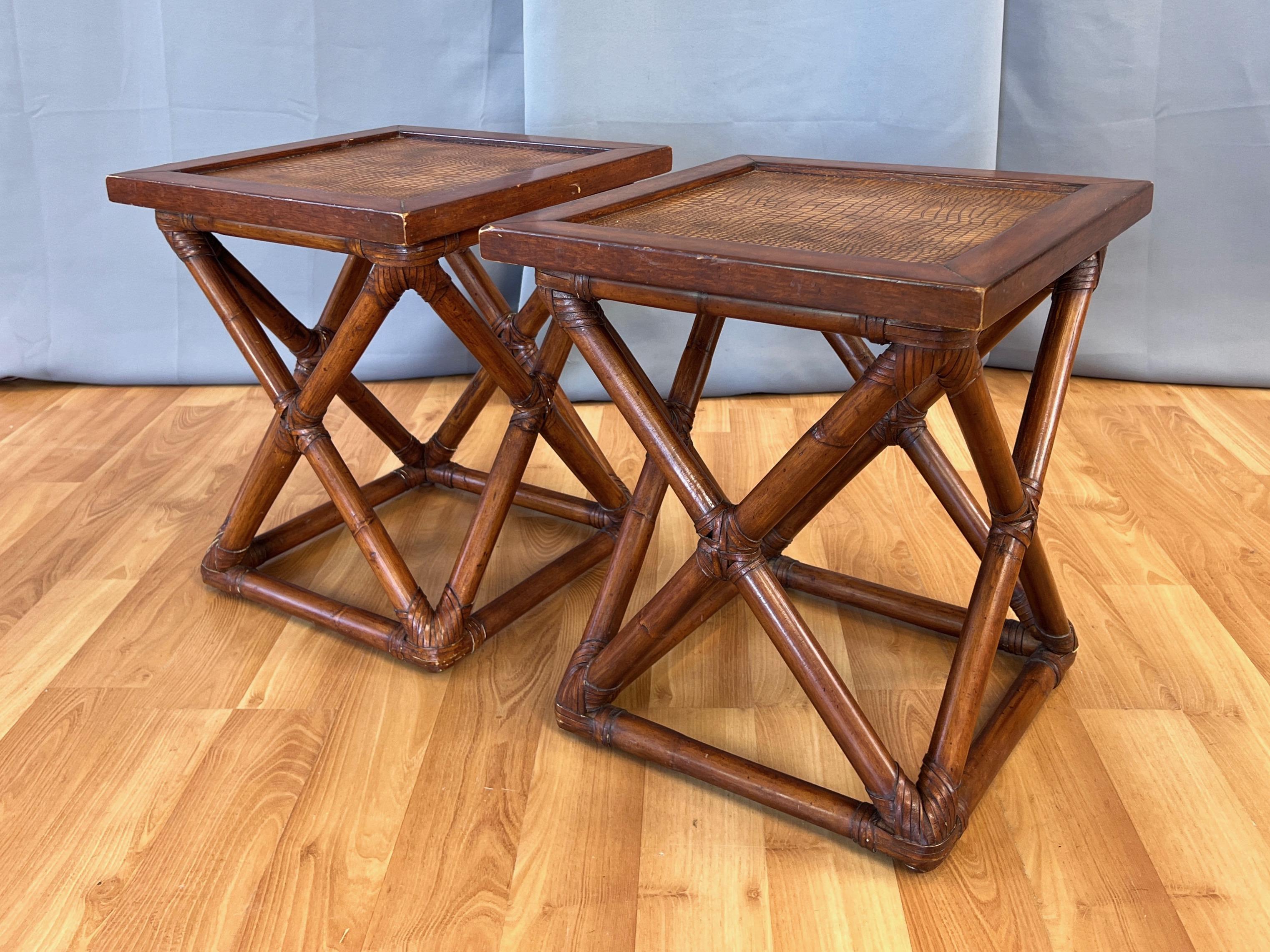 A pair of uncommon Palecek rattan and mahogany end tables with faux crocodile or alligator leather tops.

Rattan base features X-shaped sides and square bottom with wrapped and woven flat leather cord binding at all points of joinery. Mahogany